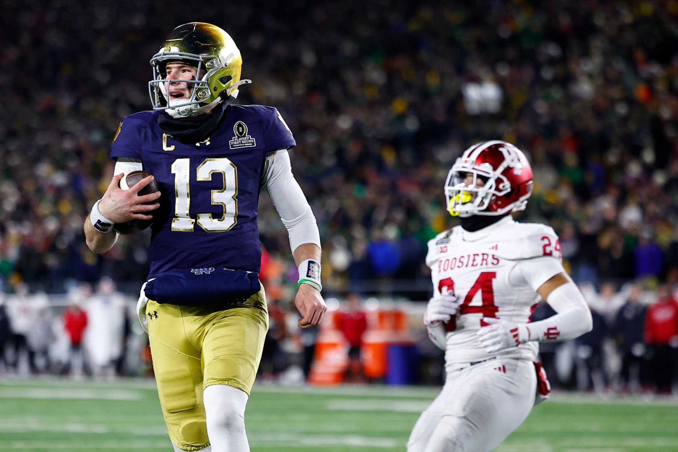 SOUTH BEND, IN - DECEMBER 20: Notre Dame Fighting Irish quarterback Riley Leonard (13) runs in for the touchdown in the fourth quarter of play during the CFP first round game between the Indiana Hoosiers and Notre Dame Fighting Irish on December 20, 2024 at Notre Dame Stadium in South Bend, IN.  (Photo by Jeffrey Brown/Icon Sportswire via Getty Images)