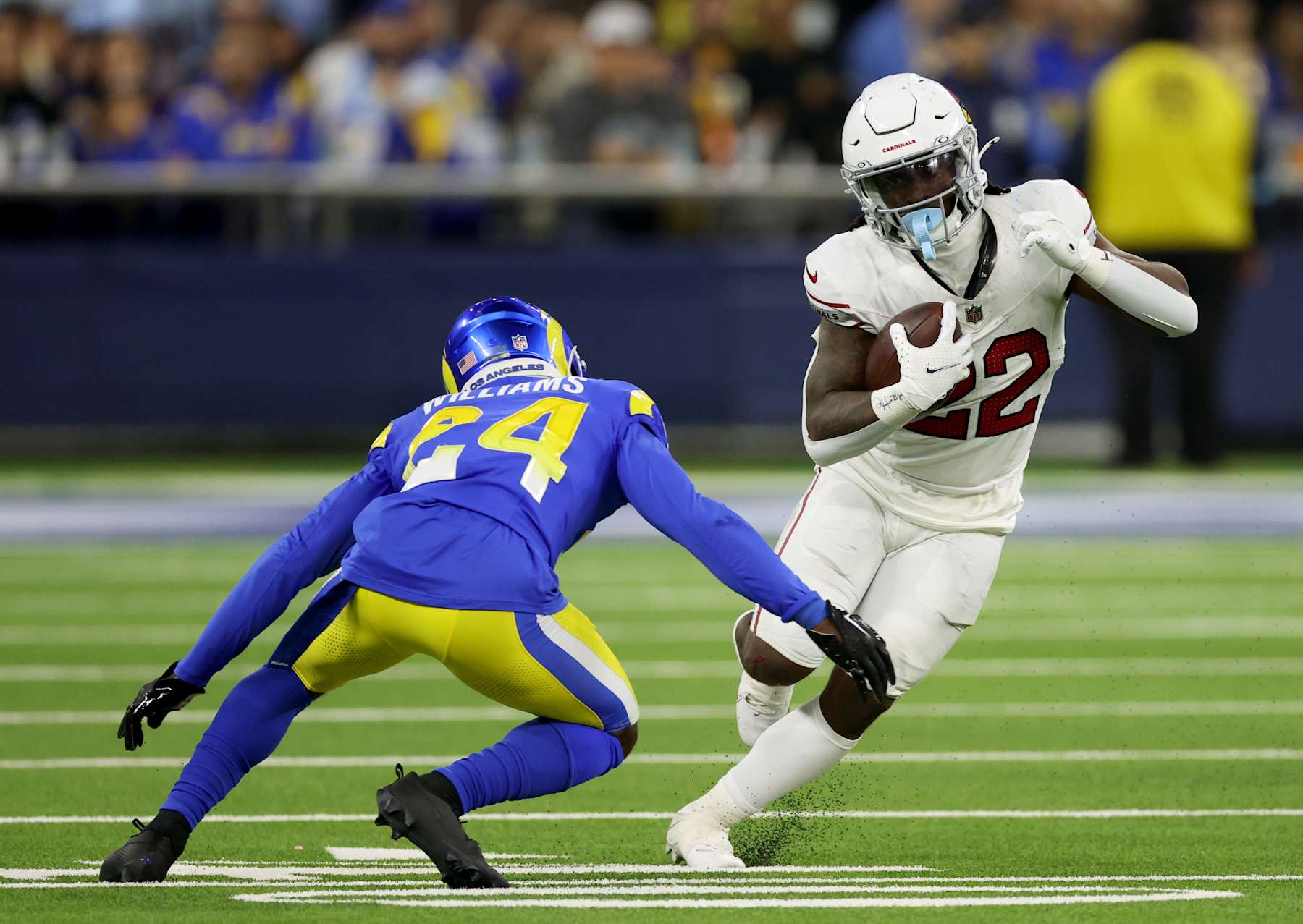INGLEWOOD, CALIFORNIA - DECEMBER 28: Michael Carter #22 of the Arizona Cardinals cuts back on his run in front of Darious Williams #24 of the Los Angeles Rams during a 13-9 loss to the Los Angeles Rams at SoFi Stadium on December 28, 2024 in Inglewood, California. (Photo by Harry How/Getty Images)