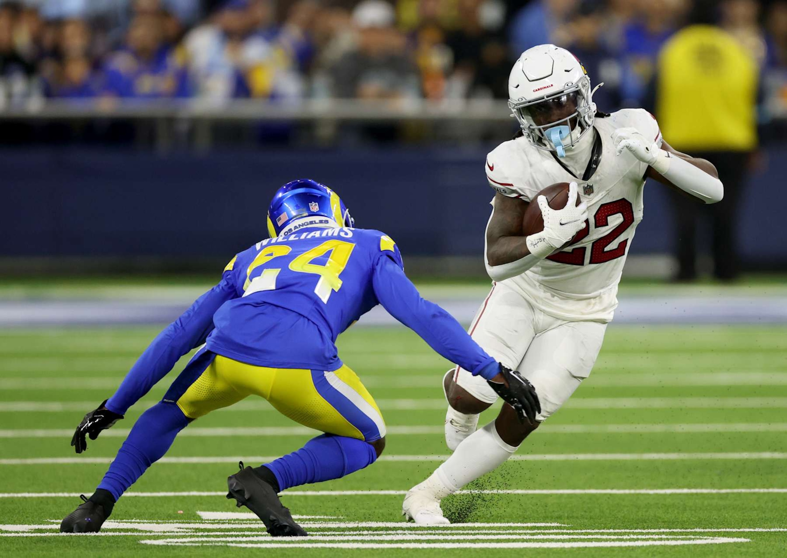INGLEWOOD, CALIFORNIA - DECEMBER 28: Michael Carter #22 of the Arizona Cardinals cuts back on his run in front of Darious Williams #24 of the Los Angeles Rams during a 13-9 loss to the Los Angeles Rams at SoFi Stadium on December 28, 2024 in Inglewood, California. (Photo by Harry How/Getty Images)