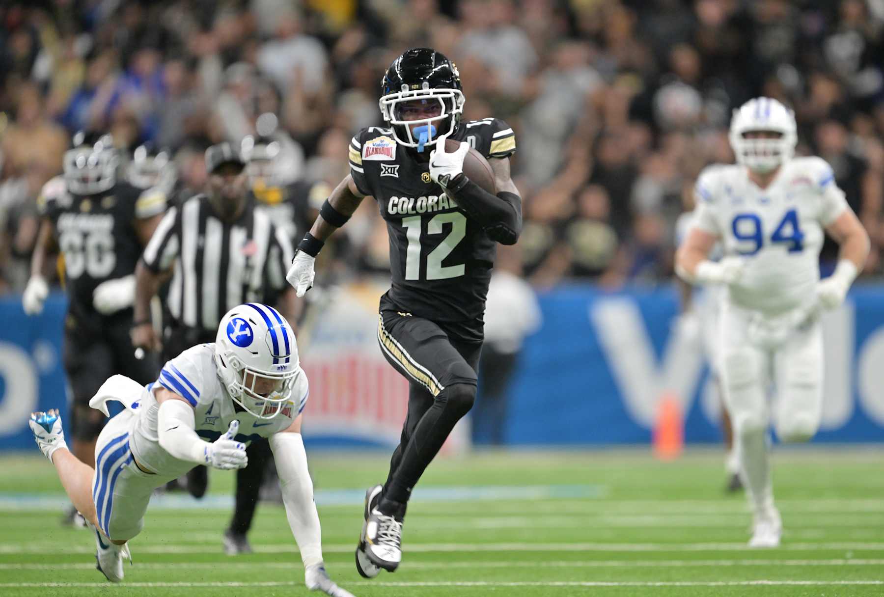 SAN ANTONIO, TEXAS - DECEMBER 28: Colorado Buffaloes wide receiver Travis Hunter (12) makes catch and turns up field for extra yards at the Alamodome in San Antonio, Texas on December 28, 2024. The Colorado Buffaloes played the Brigham Young Cougars in the Valero Alamo Bowl. (Photo by RJ Sangosti/MediaNews Group/The Denver Post via Getty Images)