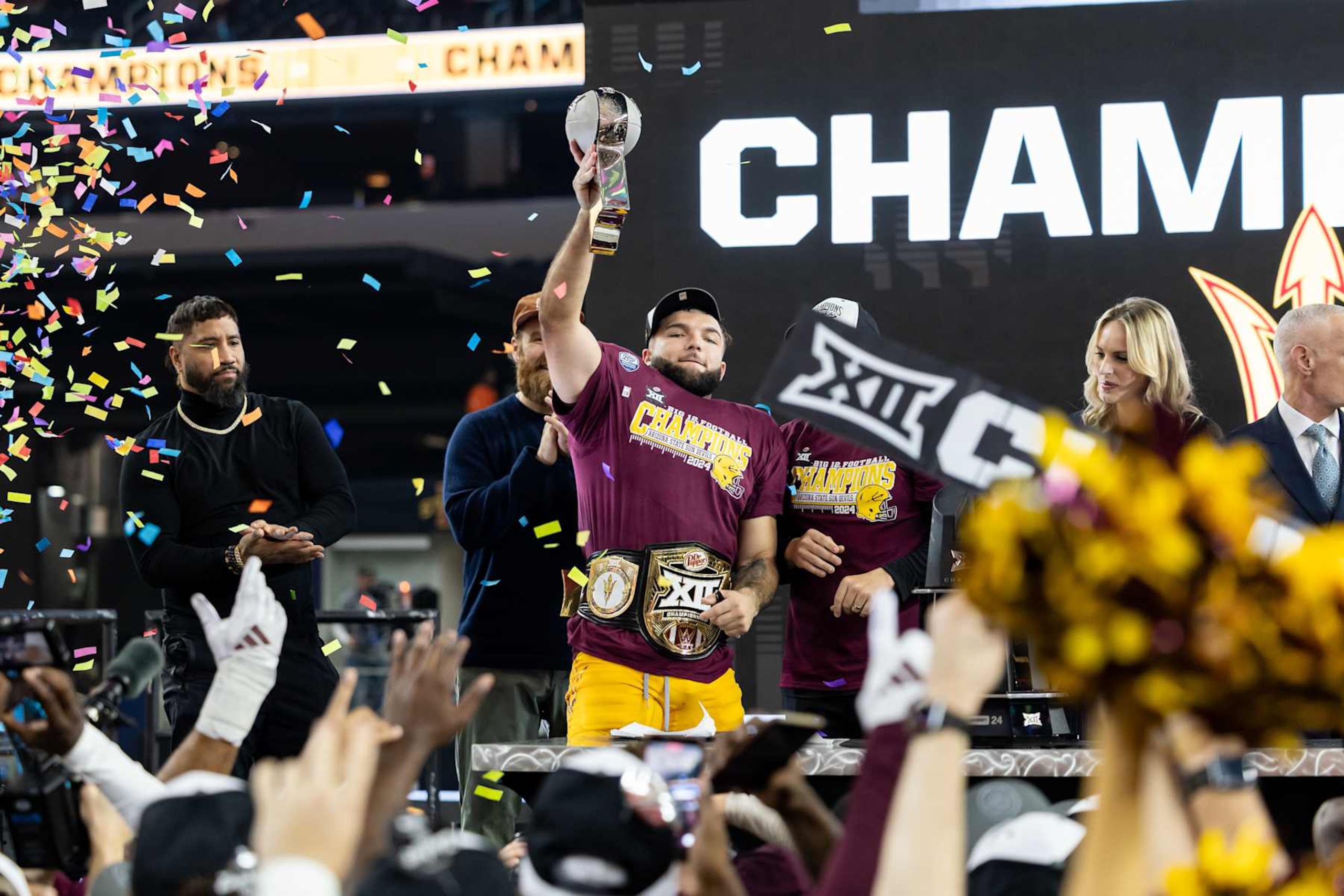 ARLINGTON, TX - DECEMBER 07: Arizona State Sun Devils running back Cam Skattebo (#4) lifts the championship trophy during the Big 12 championship football game between the Arizona State Sun Devils and the Iowa State Cyclones on December 7, 2024 at AT&T Stadium in Arlington, TX.  (Photo by Matthew Visinsky/Icon Sportswire via Getty Images)