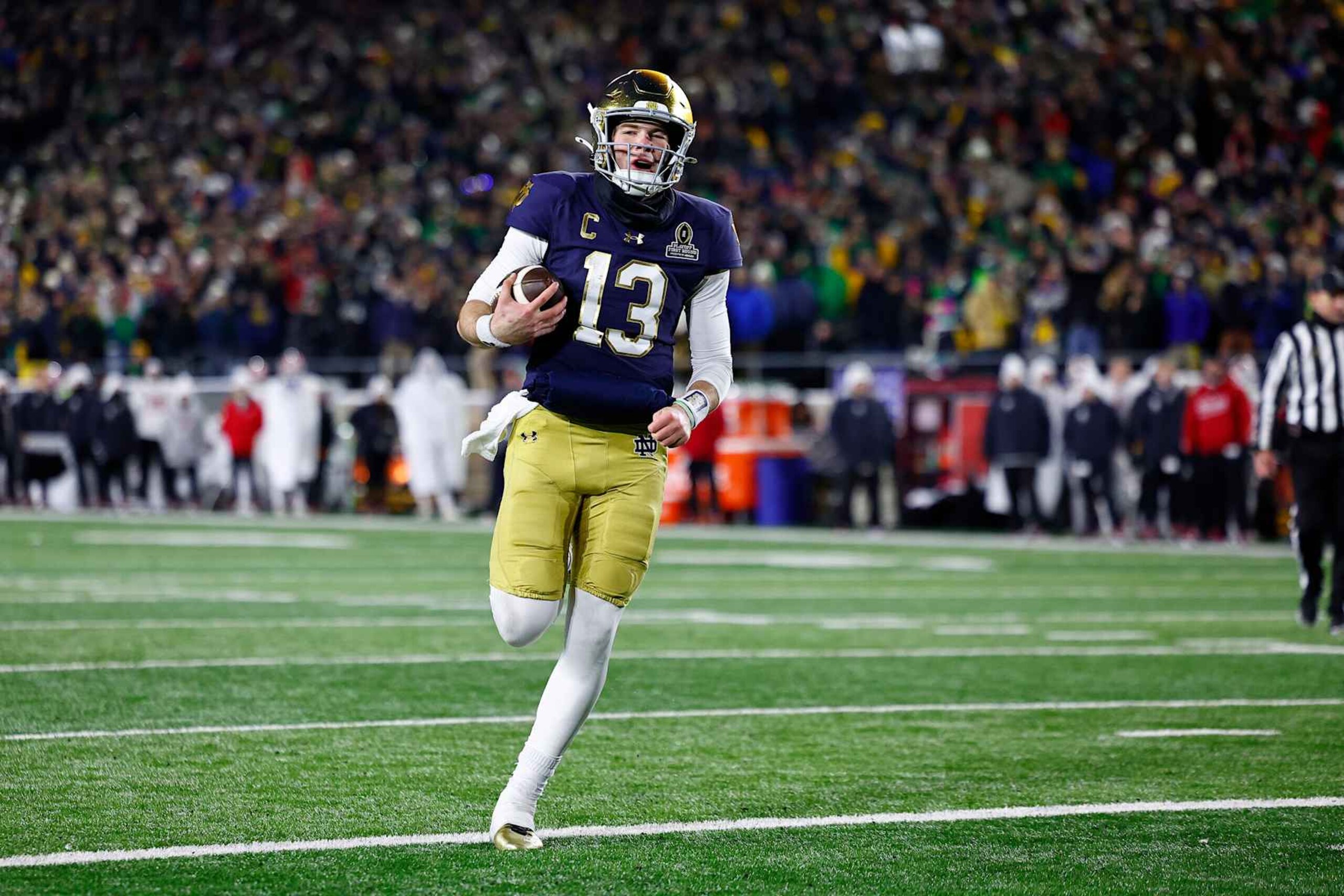 SOUTH BEND, IN - DECEMBER 20: Notre Dame Fighting Irish quarterback Riley Leonard (13) runs in for the touchdown in the fourth quarter of play during the CFP first round game between the Indiana Hoosiers and Notre Dame Fighting Irish on December 20, 2024 at Notre Dame Stadium in South Bend, IN.  (Photo by Jeffrey Brown/Icon Sportswire via Getty Images)