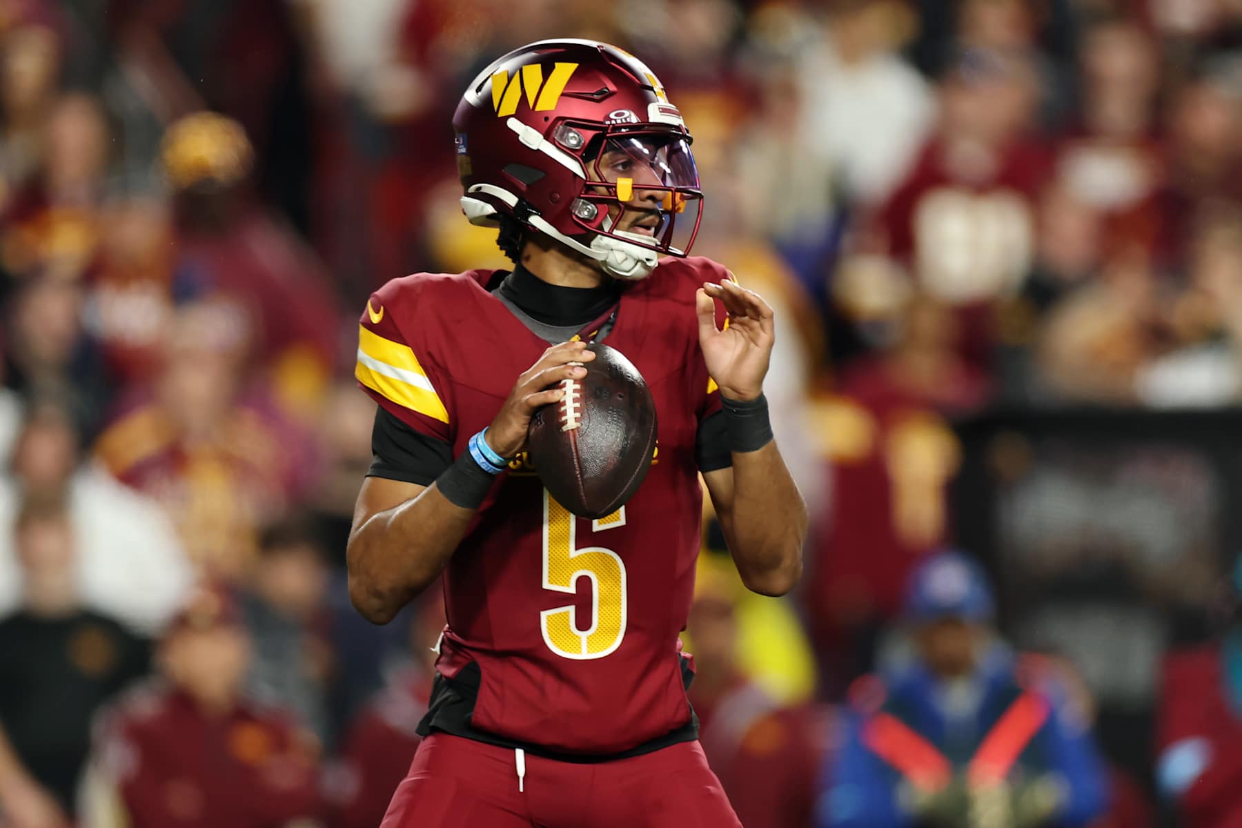 LANDOVER, MARYLAND - DECEMBER 29: Jayden Daniels #5 of the Washington Commanders drops back to pass in the first quarter against the Atlanta Falcons at Northwest Stadium on December 29, 2024 in Landover, Maryland. (Photo by Scott Taetsch/Getty Images)