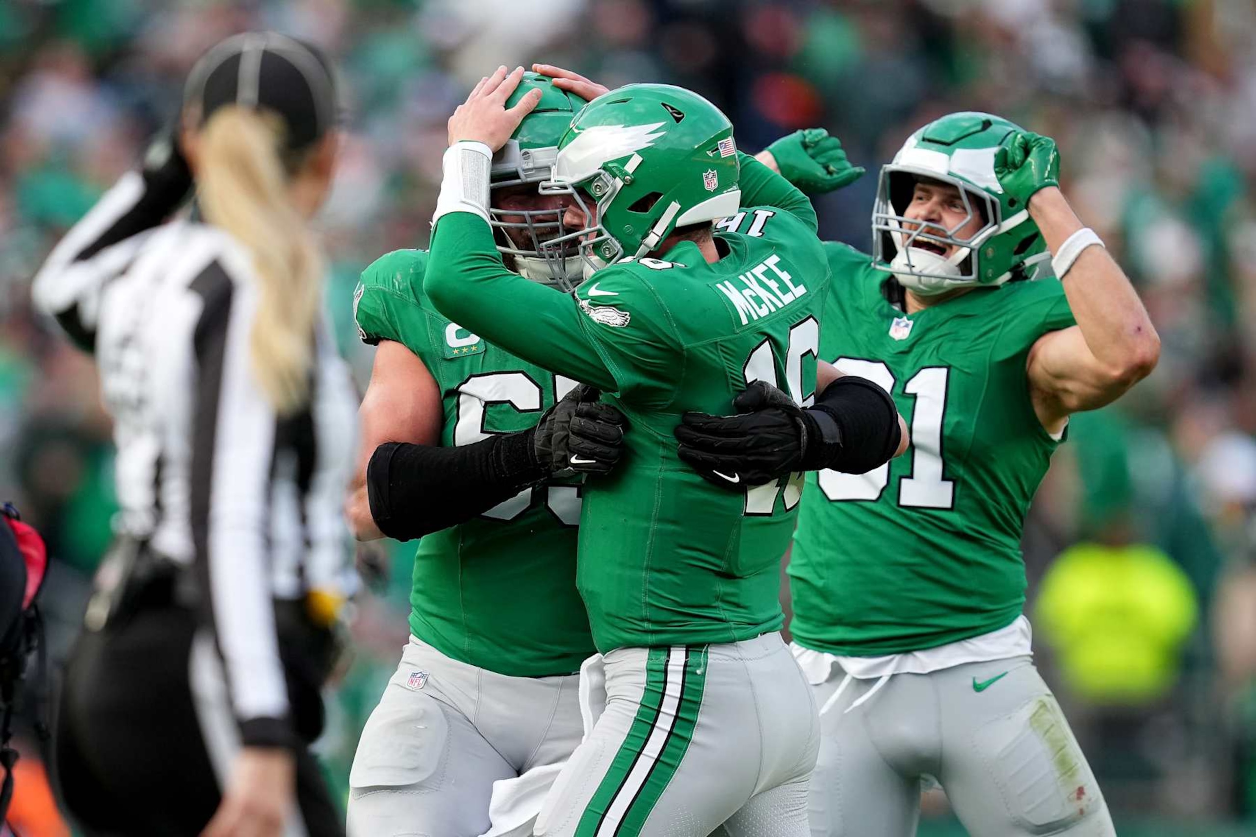PHILADELPHIA, PENNSYLVANIA - DECEMBER 29: Tanner McKee #16 of the Philadelphia Eagles celebrates with teammates Lane Johnson #65 and Grant Calcaterra #81 after throwing a touchdown pass against the Dallas Cowboys during the third quarter at Lincoln Financial Field on December 29, 2024 in Philadelphia, Pennsylvania. (Photo by Mitchell Leff/Getty Images)