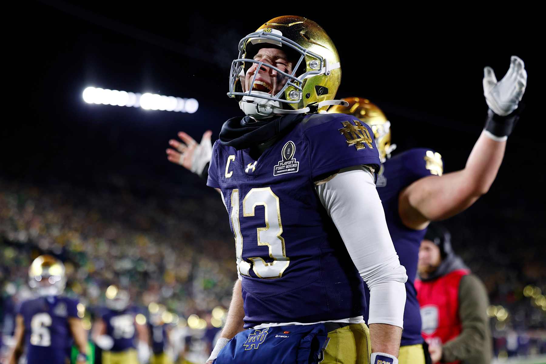 SOUTH BEND, IN - DECEMBER 20: Notre Dame Fighting Irish quarterback Riley Leonard (13) celebrates his touchdown in the fourth quarter of play during the CFP first round game between the Indiana Hoosiers and Notre Dame Fighting Irish on December 20, 2024 at Notre Dame Stadium in South Bend, IN.  (Photo by Jeffrey Brown/Icon Sportswire via Getty Images)
