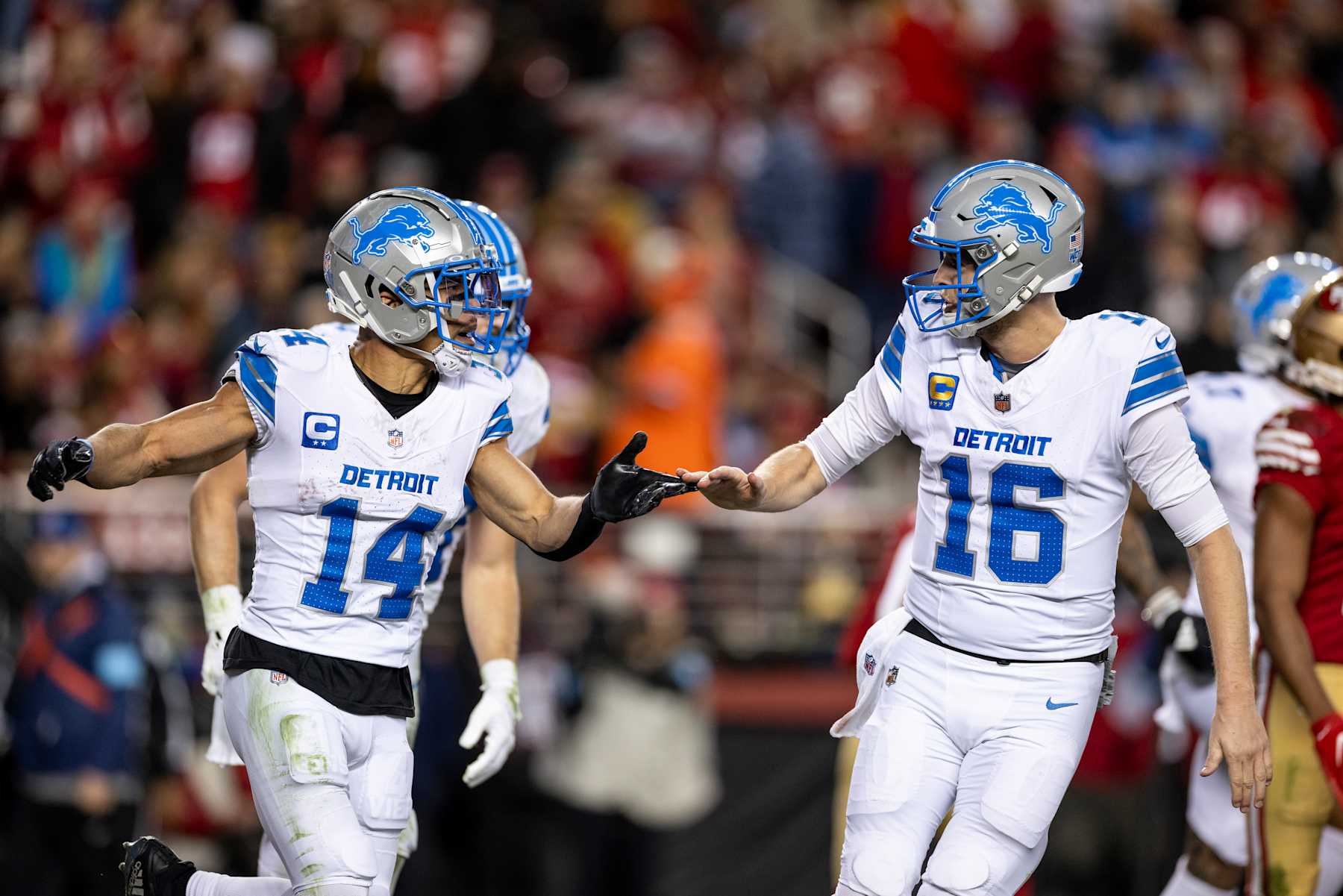 SANTA CLARA, CALIFORNIA - DECEMBER 30: Amon-Ra St. Brown #14 of the Detroit Lions celebrates with his teammate Jared Goff #16 of the Detroit Lions during an NFL Football game against the San Francisco 49ers at Levi's Stadium on December 30, 2024 in Santa Clara, California. (Photo by Michael Owens/Getty Images)