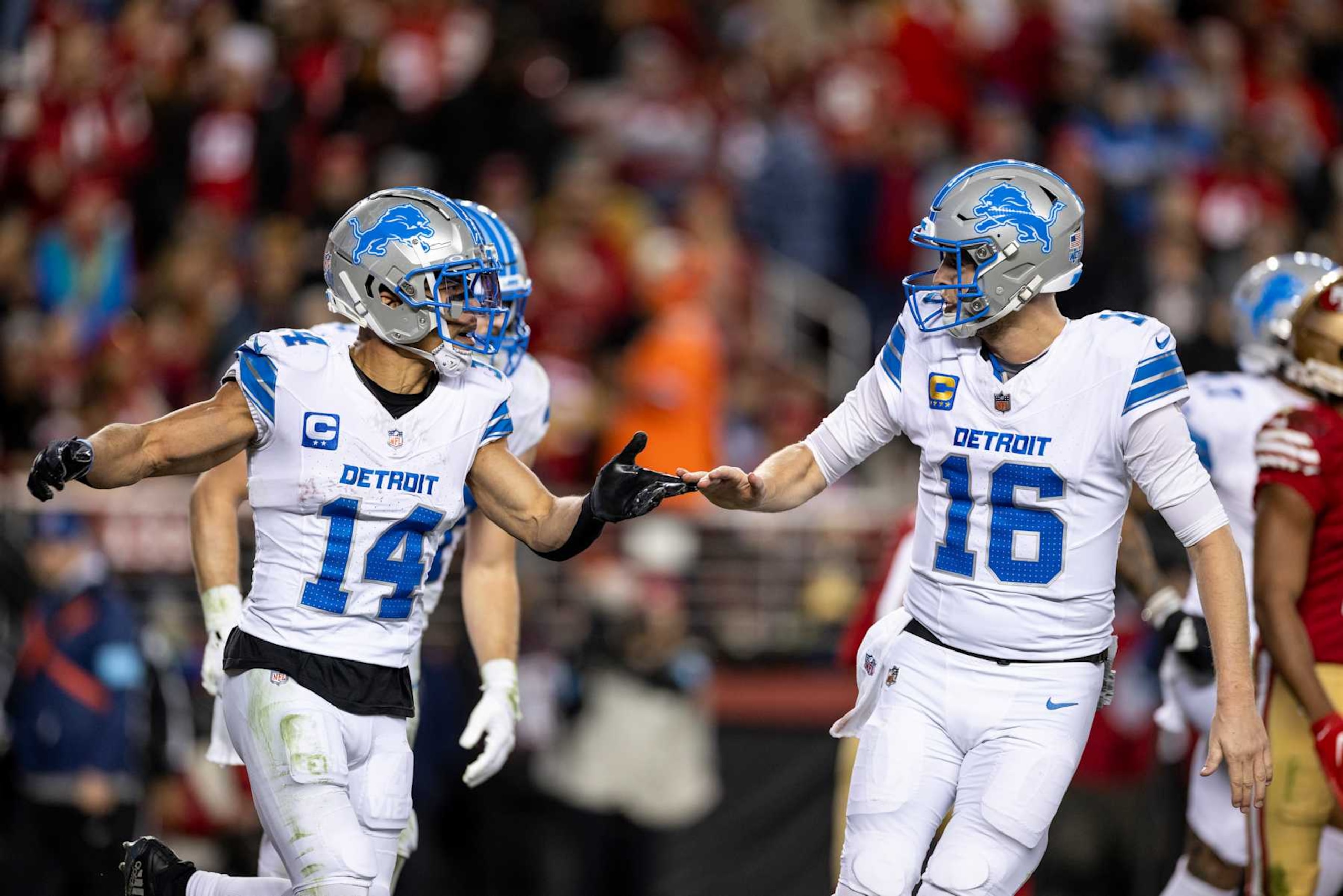 SANTA CLARA, CALIFORNIA - DECEMBER 30: Amon-Ra St. Brown #14 of the Detroit Lions celebrates with his teammate Jared Goff #16 of the Detroit Lions during an NFL Football game against the San Francisco 49ers at Levi's Stadium on December 30, 2024 in Santa Clara, California. (Photo by Michael Owens/Getty Images)