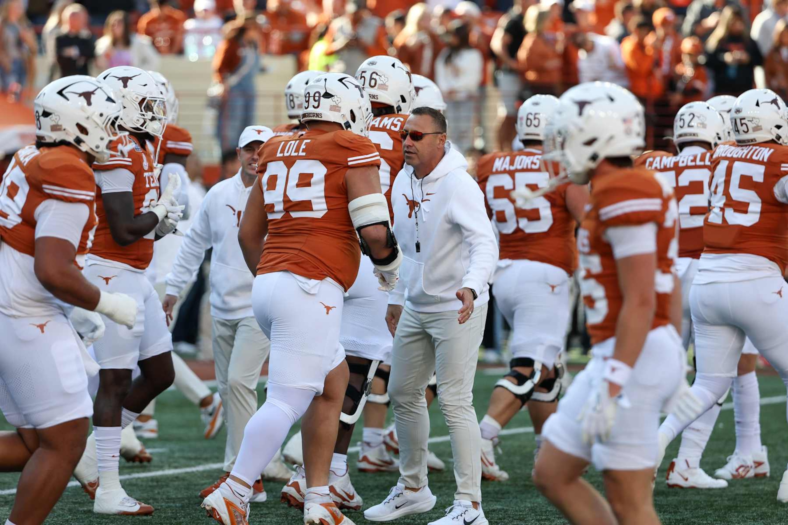 AUSTIN, TX - DECEMBER 21: Texas Longhorns head coach Steve Sarkisian high fives players during warmups before the CFP First Round game between Texas Longhorns and Clemson Tigers on December 21, 2024, at Darrell K Royal - Texas Memorial Stadium in Austin, TX. (Photo by David Buono/Icon Sportswire via Getty Images)