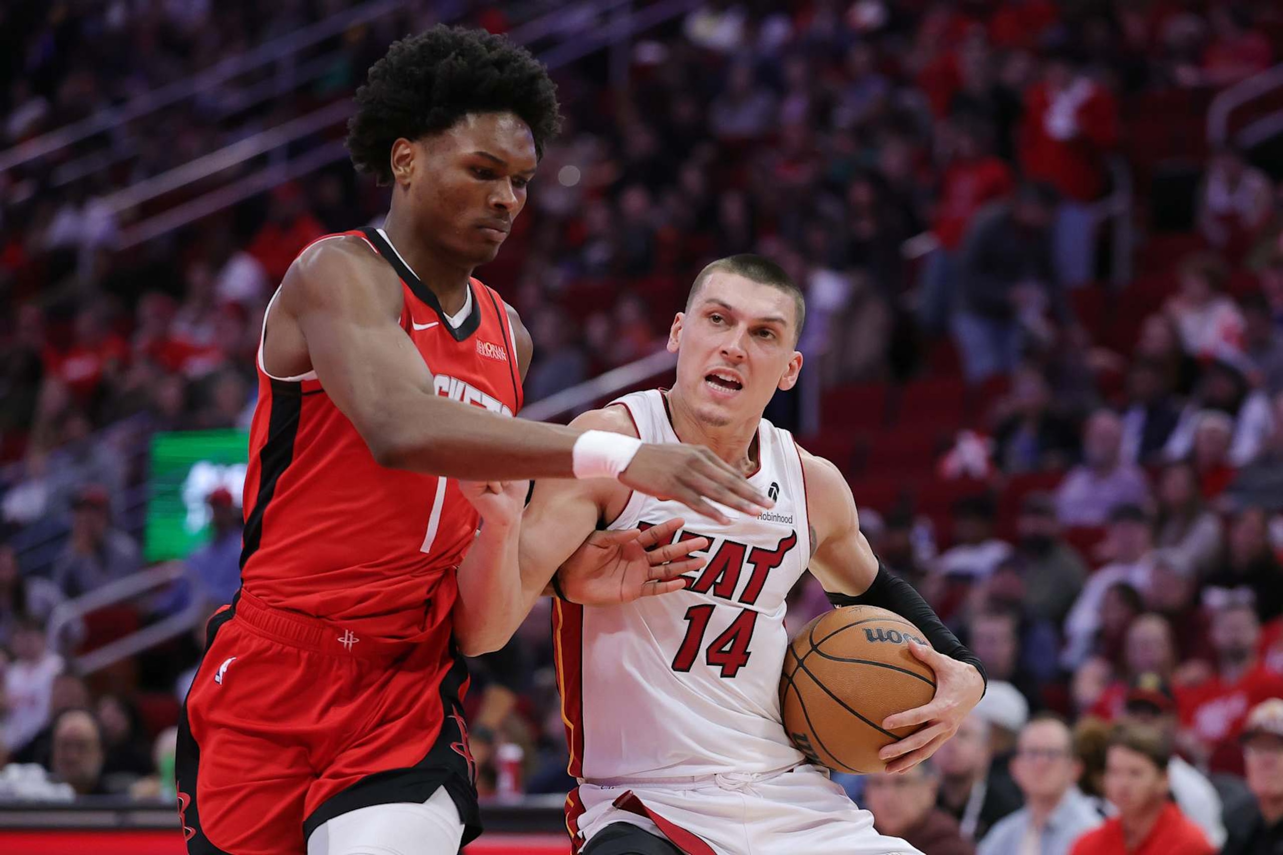 HOUSTON, TEXAS - DECEMBER 29: Tyler Herro #14 of the Miami Heat works against Amen Thompson #1 of the Houston Rockets during the first half at Toyota Center on December 29, 2024 in Houston, Texas. NOTE TO USER: User expressly acknowledges and agrees that, by downloading and or using this photograph, User is consenting to the terms and conditions of the Getty Images License Agreement. (Photo by Alex Slitz/Getty Images) HOUSTON, TEXAS - DECEMBER 29: Tyler Herro #14 of the Miami Heat works against Amen Thompson #1 of the Houston Rockets during the first half at Toyota Center on December 29, 2024 in Houston, Texas. NOTE TO USER: User expressly acknowledges and agrees that, by downloading and or using this photograph, User is consenting to the terms and conditions of the Getty Images License Agreement. (Photo by Alex Slitz/Getty Images)