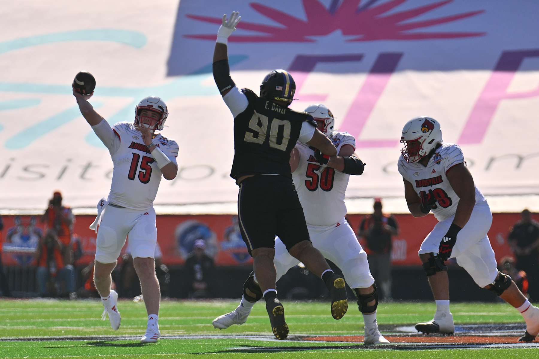 EL PASO, TEXAS - DECEMBER 31: Quarterback Harrison Bailey #15 of the Louisville Cardinals passes as offensive lineman Pete Nygra #50 blocks defensive lineman Elinneus Davis #90 of the Washington Huskies during the first half of the Tony the Tiger Sun Bowl at Sun Bowl Stadium on December 31, 2024 in El Paso, Texas. (Photo by Sam Wasson/Getty Images)