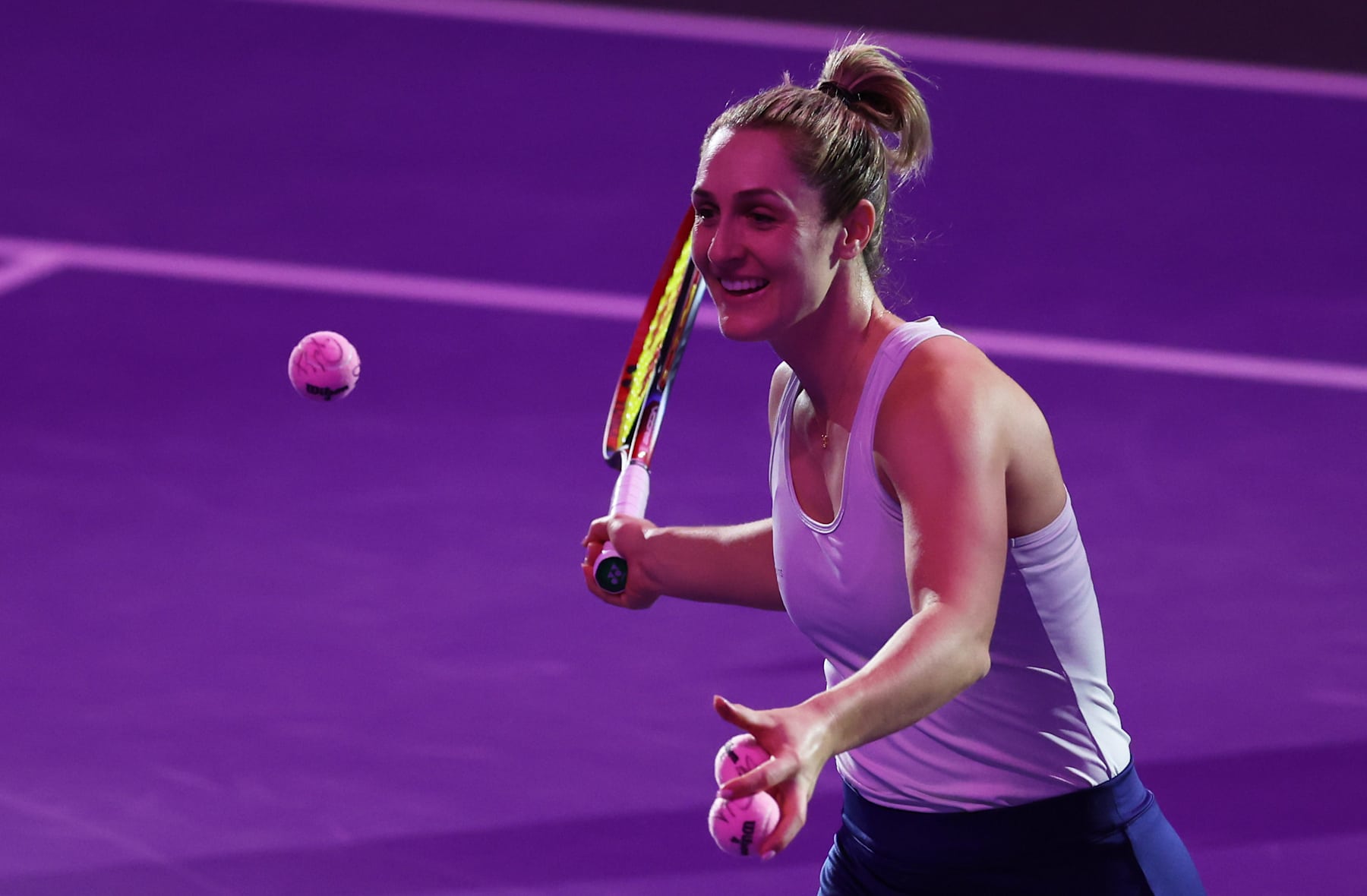 RIYADH, SAUDI ARABIA - NOVEMBER 07: Gabriela Dabrowski of Canada hits pink signed tennis balls for breast cancer awareness into the crowd with Erin Routliffe of New Zealand i(out of pic) after their victory against Caroline Dolehide of the United States and Desirae Krawczyk of the United States in their round robin doubles match during Day 6 of the 2024 WTA Finals Riyadh as part of the Hologic WTA Tour at King Saud University Indoor Arena on November 07, 2024 in Riyadh, Saudi Arabia.   (Photo by Clive Brunskill/Getty Images)