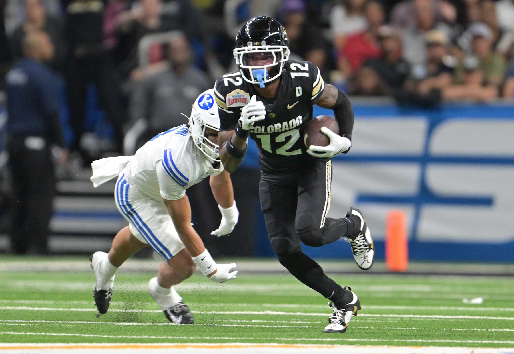 SAN ANTONIO, TEXAS - DECEMBER 28: Colorado Buffaloes wide receiver Travis Hunter (12) makes catch and turns up field for extra yards at the Alamodome in San Antonio, Texas on December 28, 2024. The Colorado Buffaloes played the Brigham Young Cougars in the Valero Alamo Bowl. (Photo by RJ Sangosti/MediaNews Group/The Denver Post via Getty Images)