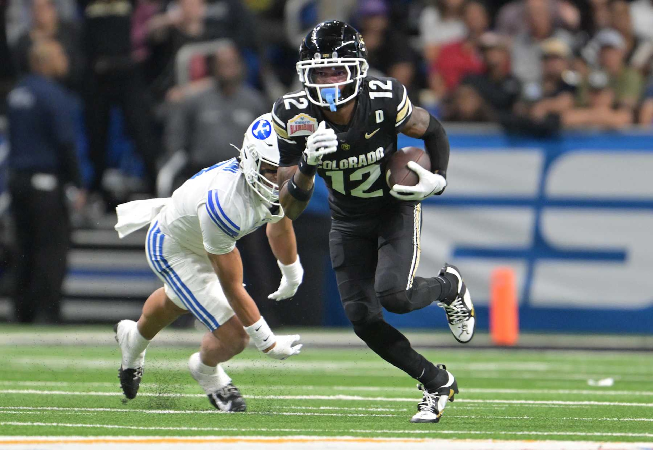 SAN ANTONIO, TEXAS - DECEMBER 28: Colorado Buffaloes wide receiver Travis Hunter (12) makes catch and turns up field for extra yards at the Alamodome in San Antonio, Texas on December 28, 2024. The Colorado Buffaloes played the Brigham Young Cougars in the Valero Alamo Bowl. (Photo by RJ Sangosti/MediaNews Group/The Denver Post via Getty Images)