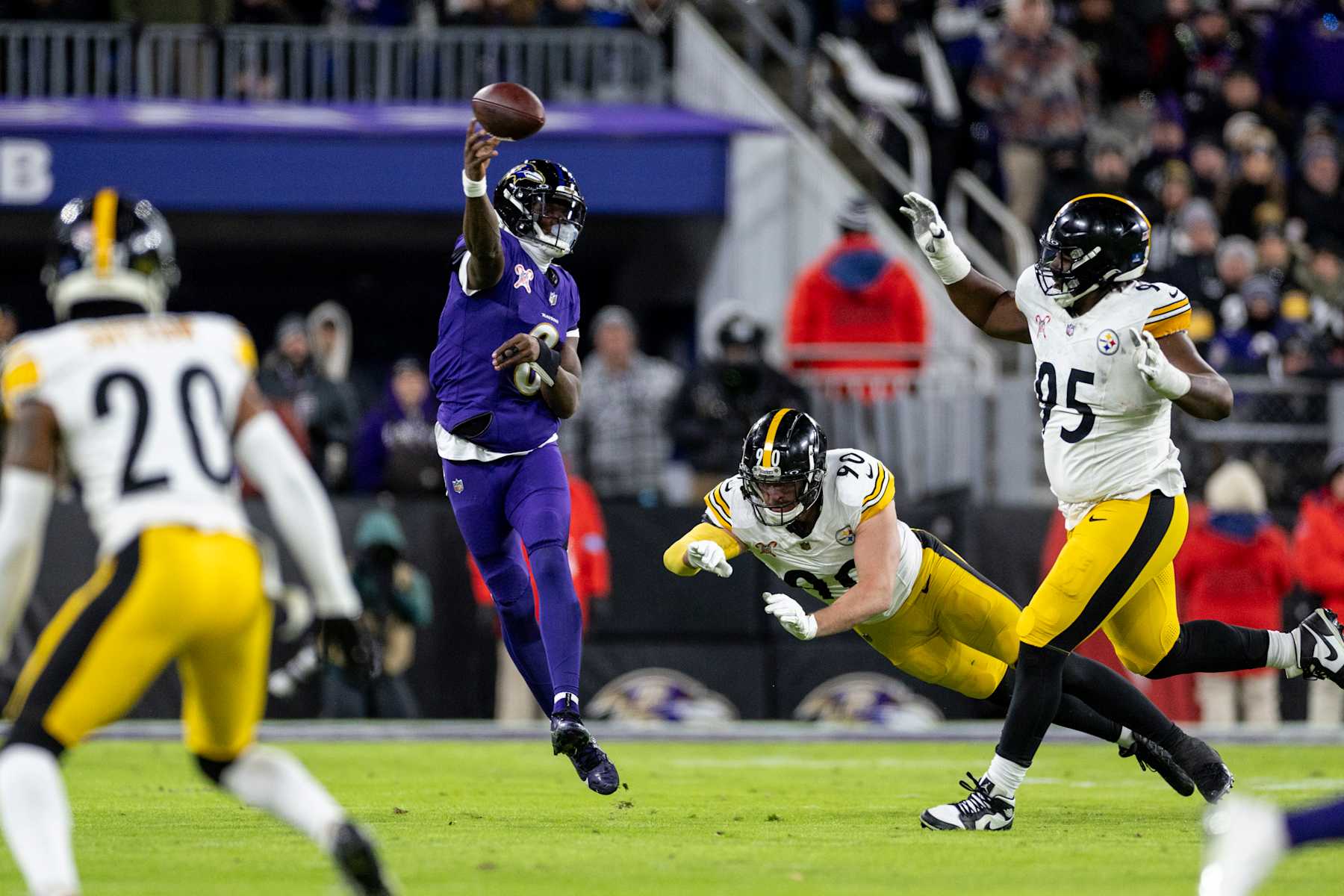 BALTIMORE, MARYLAND - DECEMBER 21: Lamar Jackson #8 of the Baltimore Ravens throws a pass on the run during an NFL Football game against the Pittsburgh Steelers at M&T Bank Stadium on December 21, 2024 in Baltimore, Maryland. (Photo by Michael Owens/Getty Images)