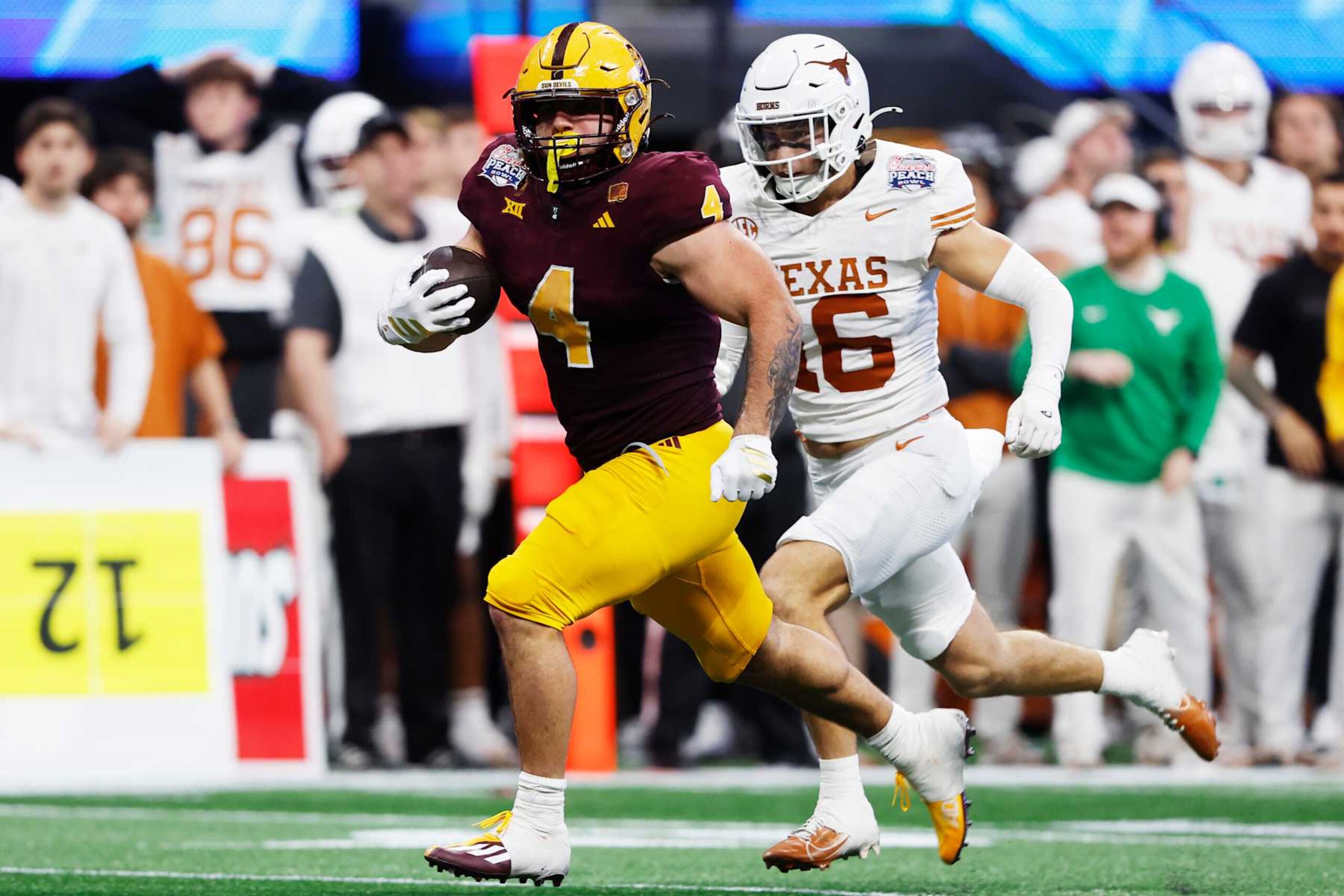 ATLANTA, GEORGIA - JANUARY 01: Cam Skattebo #4 of the Arizona State Sun Devils runs the ball during the third quarter against the Texas Longhorns in the Chick-fil-A Peach Bowl at Mercedes-Benz Stadium on January 01, 2025 in Atlanta, Georgia.  (Photo by Butch Dill/Getty Images)