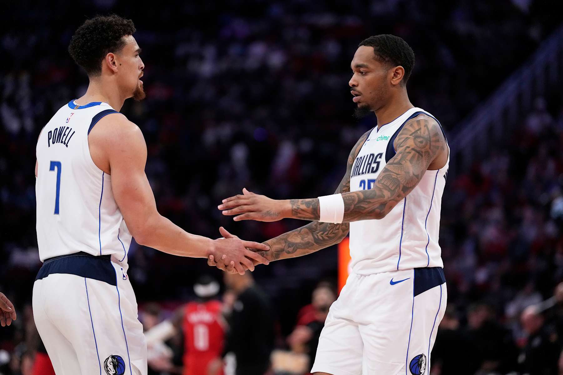 HOUSTON, TX - JANUARY 1: P.J Washington #25  and Dwight Powell #7 of the Dallas Mavericks high five during the game against the Houston Rockets  on January 1, 2025 at the Toyota Center in Houston, Texas. NOTE TO USER: User expressly acknowledges and agrees that, by downloading and or using this photograph, User is consenting to the terms and conditions of the Getty Images License Agreement. Mandatory Copyright Notice: Copyright 2025 NBAE (Photo by Kevin M.Cox/NBAE via Getty Images)