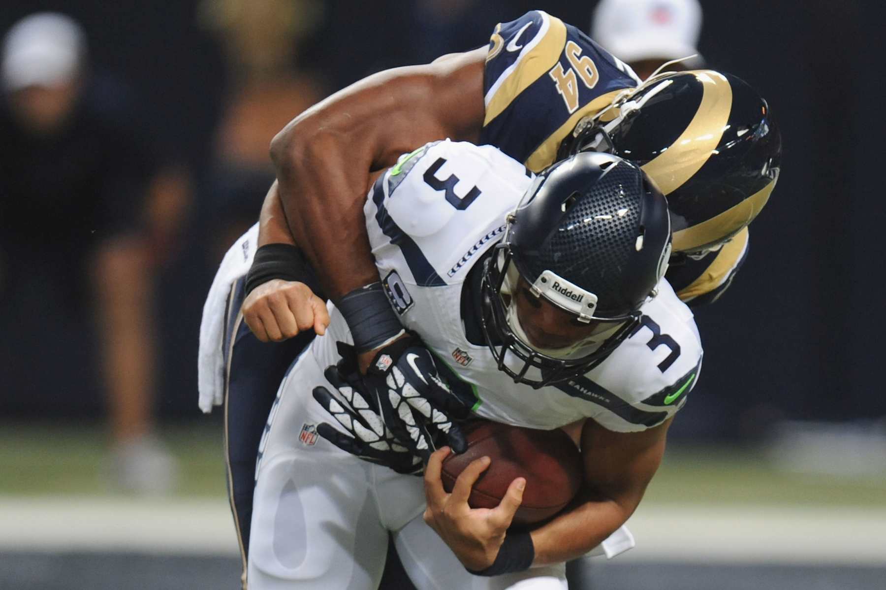 ST. LOUIS, MO - OCTOBER 28: Russell Wilson #3 of the Seattle Seahawks is sacked during the first quarter by Robert Quinn #94 of the St. Louis Rams at the Edward Jones Dome on October 28, 2013 in St. Louis, Missouri.  (Photo by Michael Thomas/Getty Images)