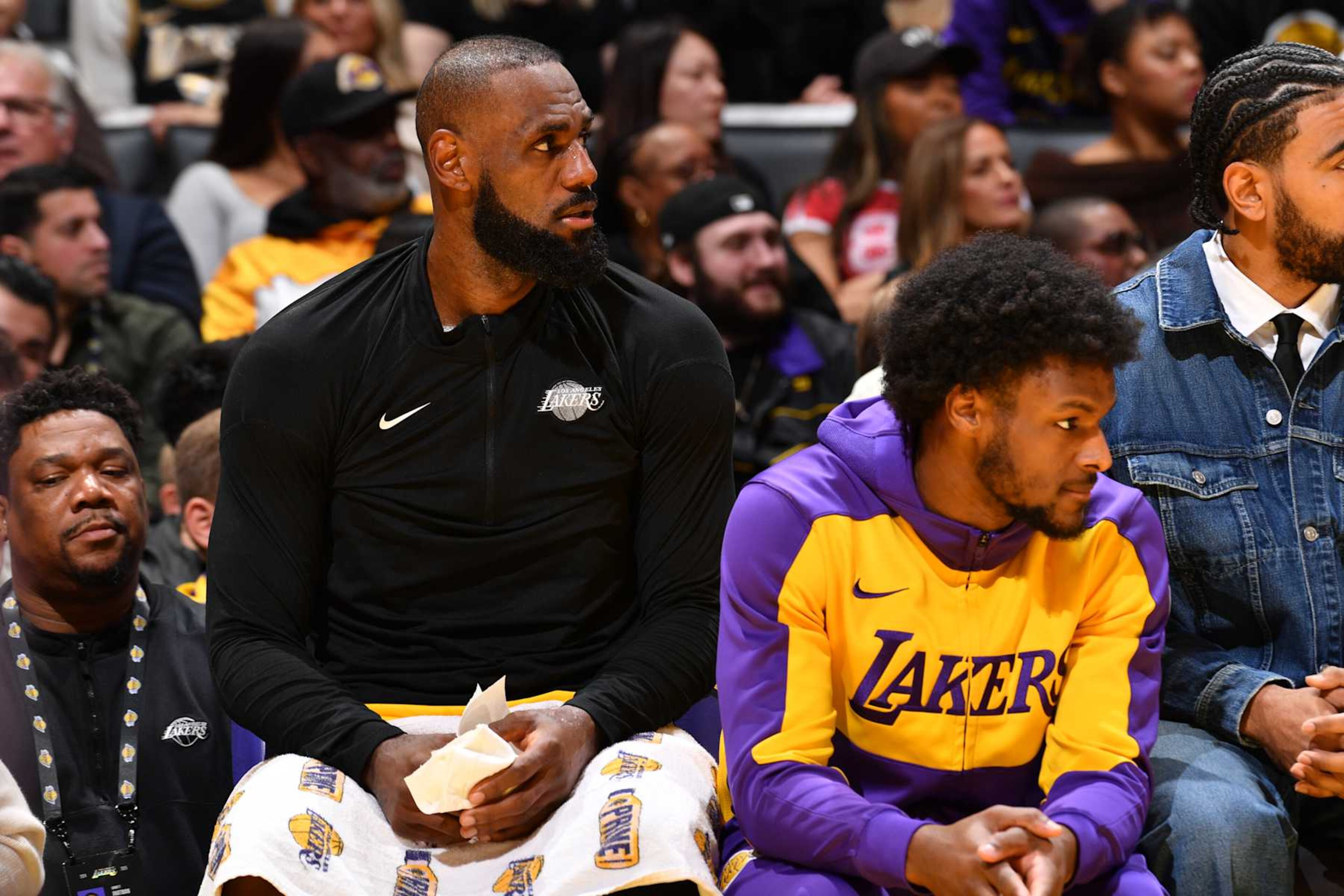 LOS ANGELES, CA - DECEMBER 31: LeBron James #23 and Bronny James #9 of the Los Angeles Lakers look on during the game against the Cleveland Cavaliers on December 31, 2024 at Crypto.Com Arena in Los Angeles, California. NOTE TO USER: User expressly acknowledges and agrees that, by downloading and/or using this Photograph, user is consenting to the terms and conditions of the Getty Images License Agreement. Mandatory Copyright Notice: Copyright 2024 NBAE (Photo by Juan Ocampo/NBAE via Getty Images) LOS ANGELES, CA - DECEMBER 31: LeBron James #23 and Bronny James #9 of the Los Angeles Lakers look on during the game against the Cleveland Cavaliers on December 31, 2024 at Crypto.Com Arena in Los Angeles, California. NOTE TO USER: User expressly acknowledges and agrees that, by downloading and/or using this Photograph, user is consenting to the terms and conditions of the Getty Images License Agreement. Mandatory Copyright Notice: Copyright 2024 NBAE (Photo by Juan Ocampo/NBAE via Getty Images)