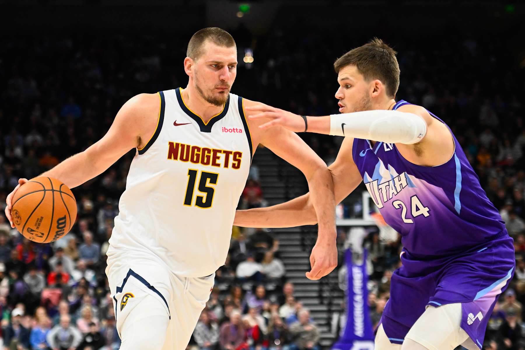 SALT LAKE CITY, UTAH - DECEMBER 30: Nikola Jokic #15 of the Denver Nuggets drives into Walker Kessler #24 of the Utah Jazz during the second half of a game at Delta Center on December 30, 2024 in Salt Lake City, Utah.  NOTE TO USER: User expressly acknowledges and agrees that, by downloading and or using this photograph, User is consenting to the terms and conditions of the Getty Images License Agreement. (Photo by Alex Goodlett/Getty Images)