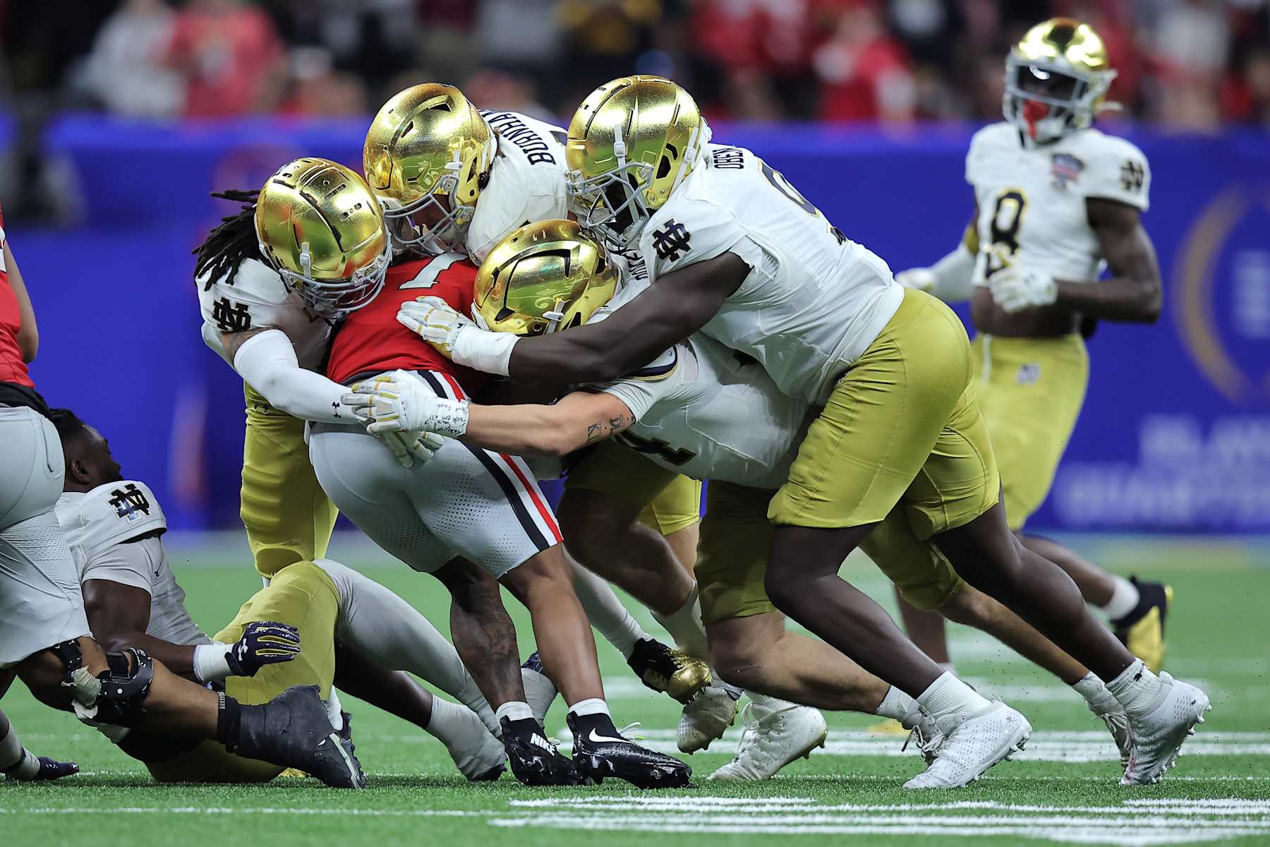 NEW ORLEANS, LOUISIANA - JANUARY 02: Trevor Etienne #1 of the Georgia Bulldogs is tackled by Notre Dame Fighting Irish players during the third quarter during the 91st Allstate Sugar Bowl at Caesars Superdome on January 02, 2025 in New Orleans, Louisiana. (Photo by Jonathan Bachman/Getty Images)