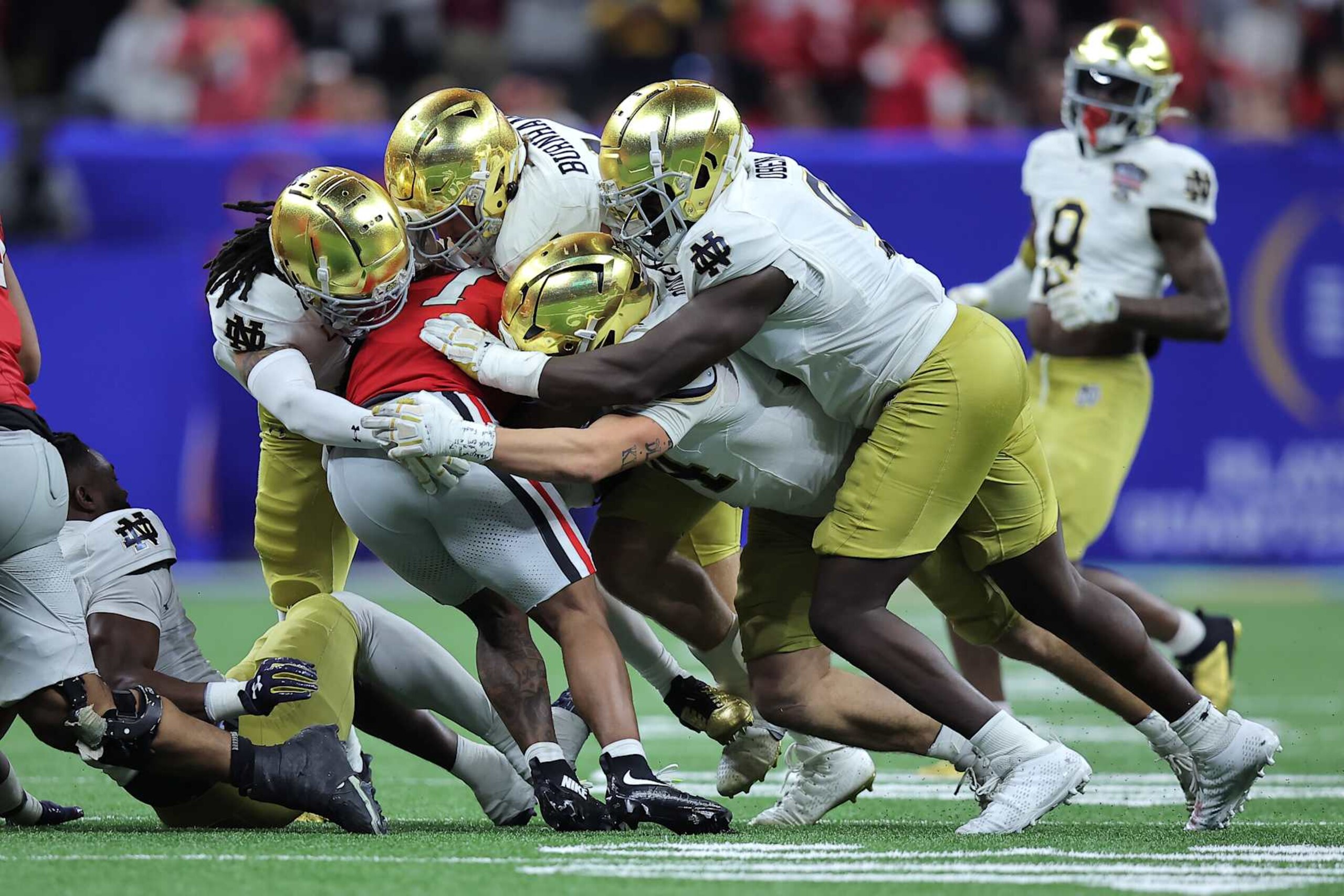 NEW ORLEANS, LOUISIANA - JANUARY 02: Trevor Etienne #1 of the Georgia Bulldogs is tackled by Notre Dame Fighting Irish players during the third quarter during the 91st Allstate Sugar Bowl at Caesars Superdome on January 02, 2025 in New Orleans, Louisiana. (Photo by Jonathan Bachman/Getty Images)