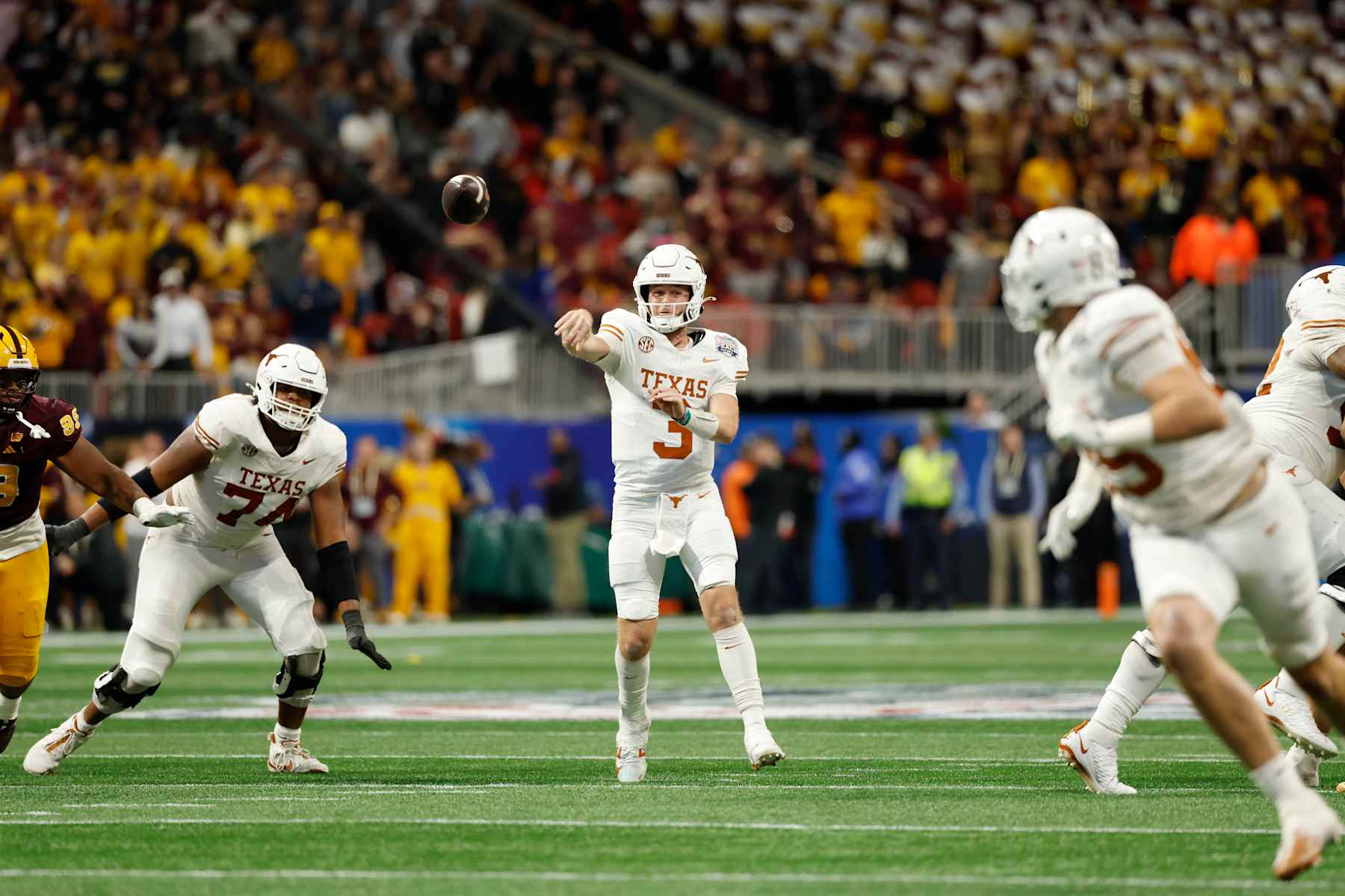ATLANTA, GA - JANUARY 01: Quarterback Quinn Ewers #3 of the Texas Longhorns passes for a 25-yard touchdown in overtime during the Texas Longhorns versus Arizona State Sun Devils College Football Playoff Quarterfinal at the Chick-fil-A Peach Bowl on January 1, 2025, at Mercedes-Benz Stadium in Atlanta, GA. (Photo by Joe Robbins/Icon Sportswire via Getty Images)