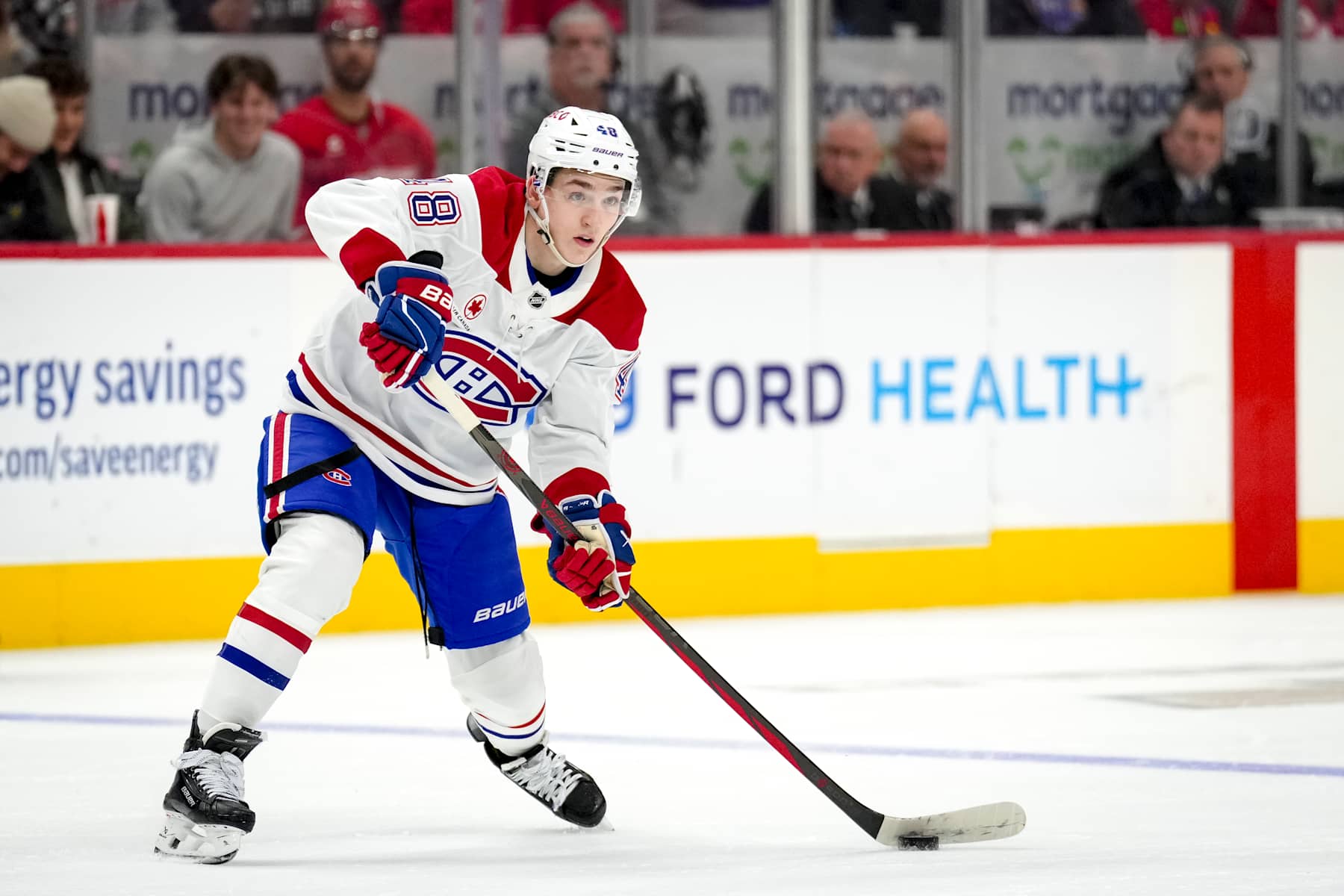 DETROIT, MICHIGAN - DECEMBER 20: Lane Hutson #48 of the Montreal Canadiens passes the puck against the Detroit Red Wings at Little Caesars Arena on December 20, 2024 in Detroit, Michigan. (Photo by Nic Antaya/Getty Images)