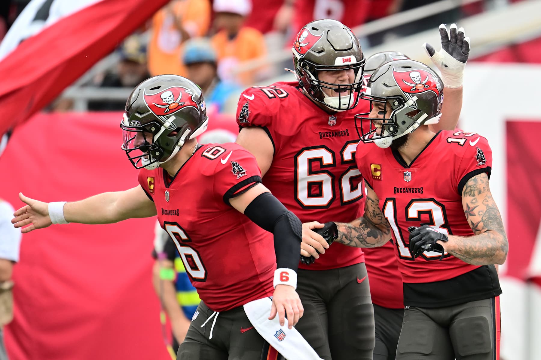 TAMPA, FLORIDA - DECEMBER 29: Mike Evans #13 of the Tampa Bay Buccaneers celebrates with Graham Barton #62 and Baker Mayfield #6 of the Tampa Bay Buccaneers after a touchdown  in the second quarter against the Carolina Panthers at Raymond James Stadium on December 29, 2024 in Tampa, Florida. (Photo by Julio Aguilar/Getty Images)