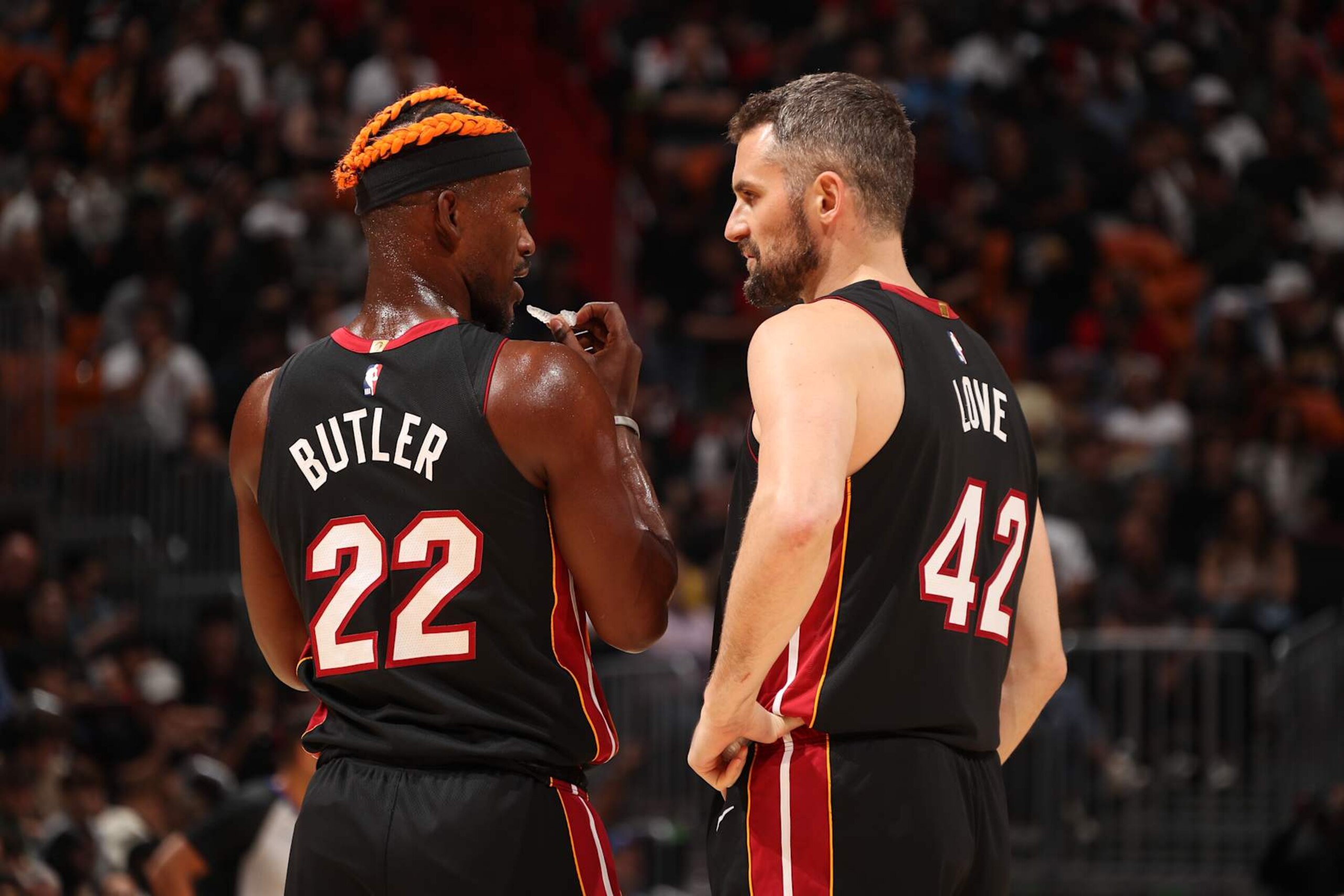 MIAMI, FL - DECEMBER 20:  Jimmy Butler #22 and Kevin Love #42 of the Miami Heat speak during the game against the Oklahoma City Thunder on December 20, 2024 at Kaseya Center in Miami, Florida. NOTE TO USER: User expressly acknowledges and agrees that, by downloading and or using this Photograph, user is consenting to the terms and conditions of the Getty Images License Agreement. Mandatory Copyright Notice: Copyright 2024 NBAE (Photo by Issac Baldizon/NBAE via Getty Images)