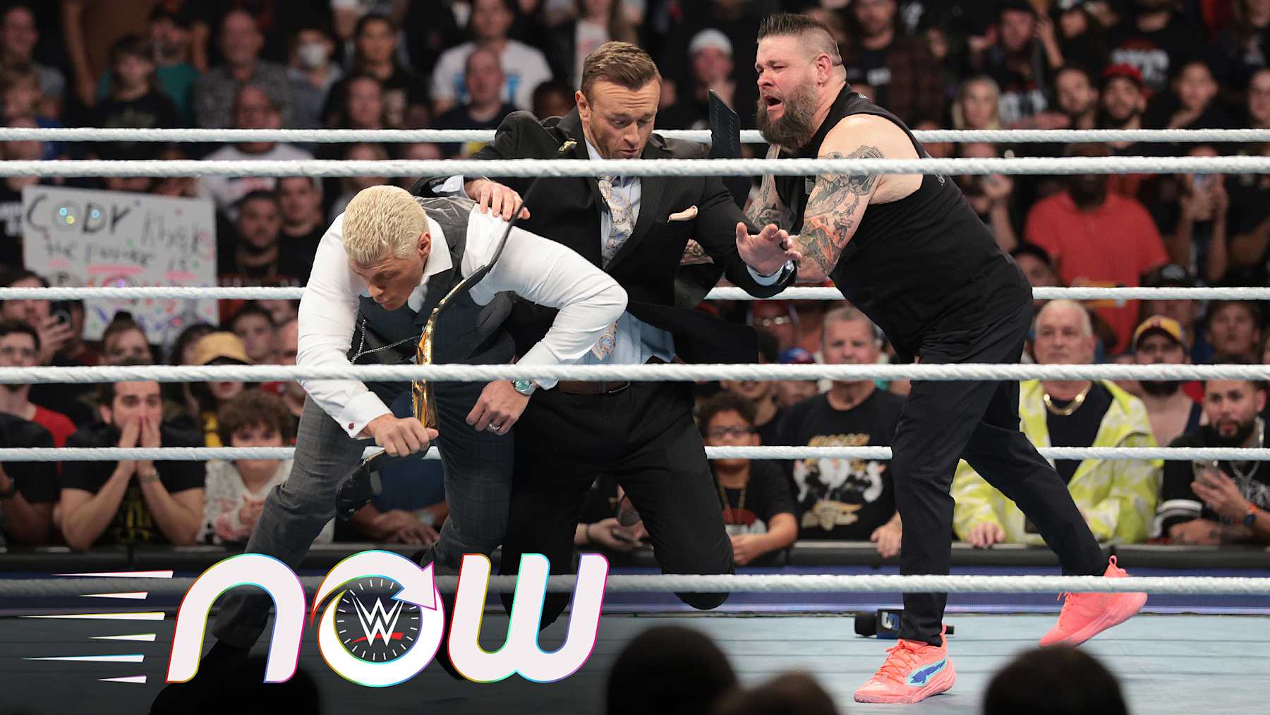 Kevin Owens pushing Nick Aldis into Cody Rhodes.