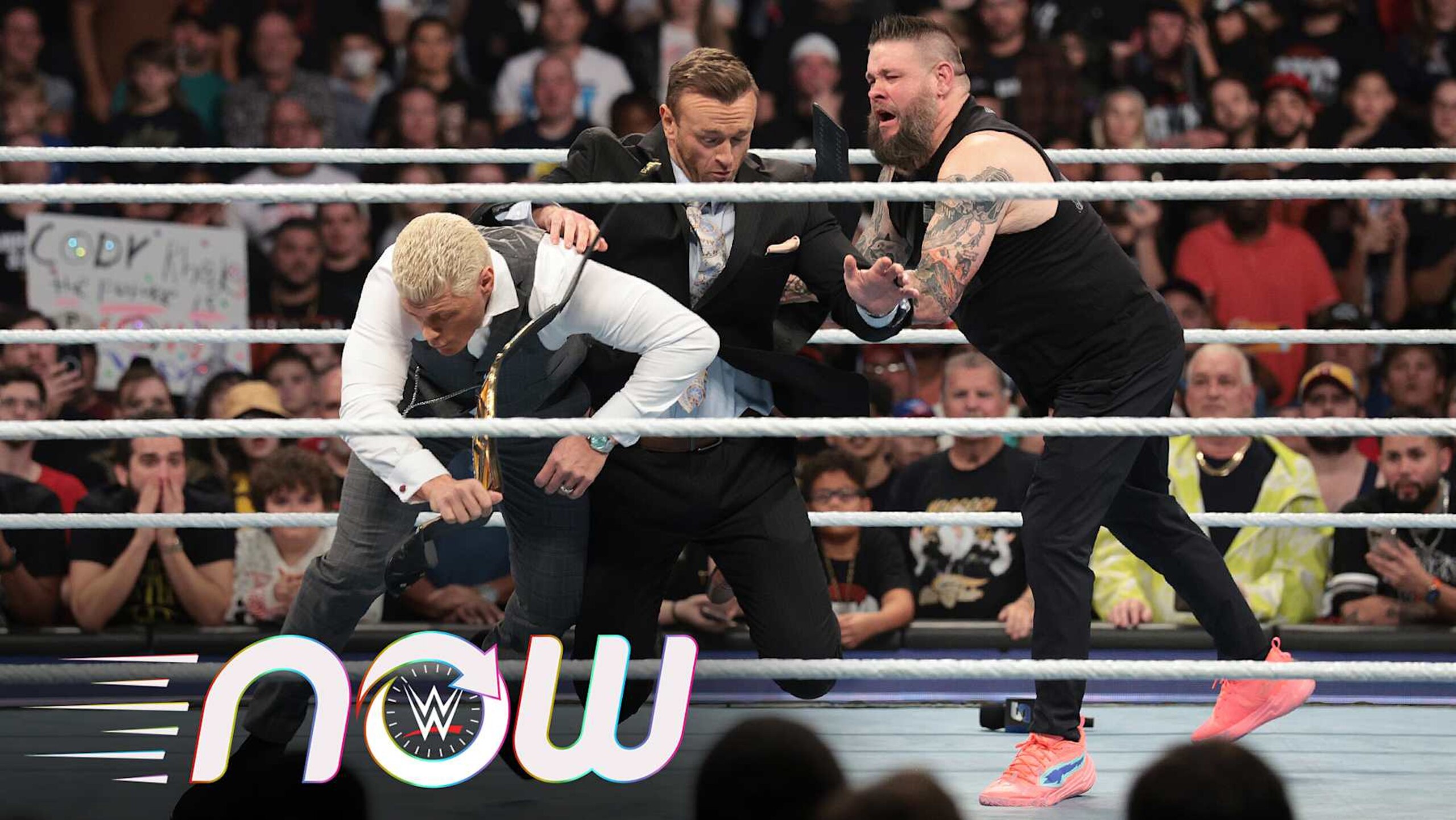 Kevin Owens pushing Nick Aldis into Cody Rhodes. Kevin Owens pushing Nick Aldis into Cody Rhodes.