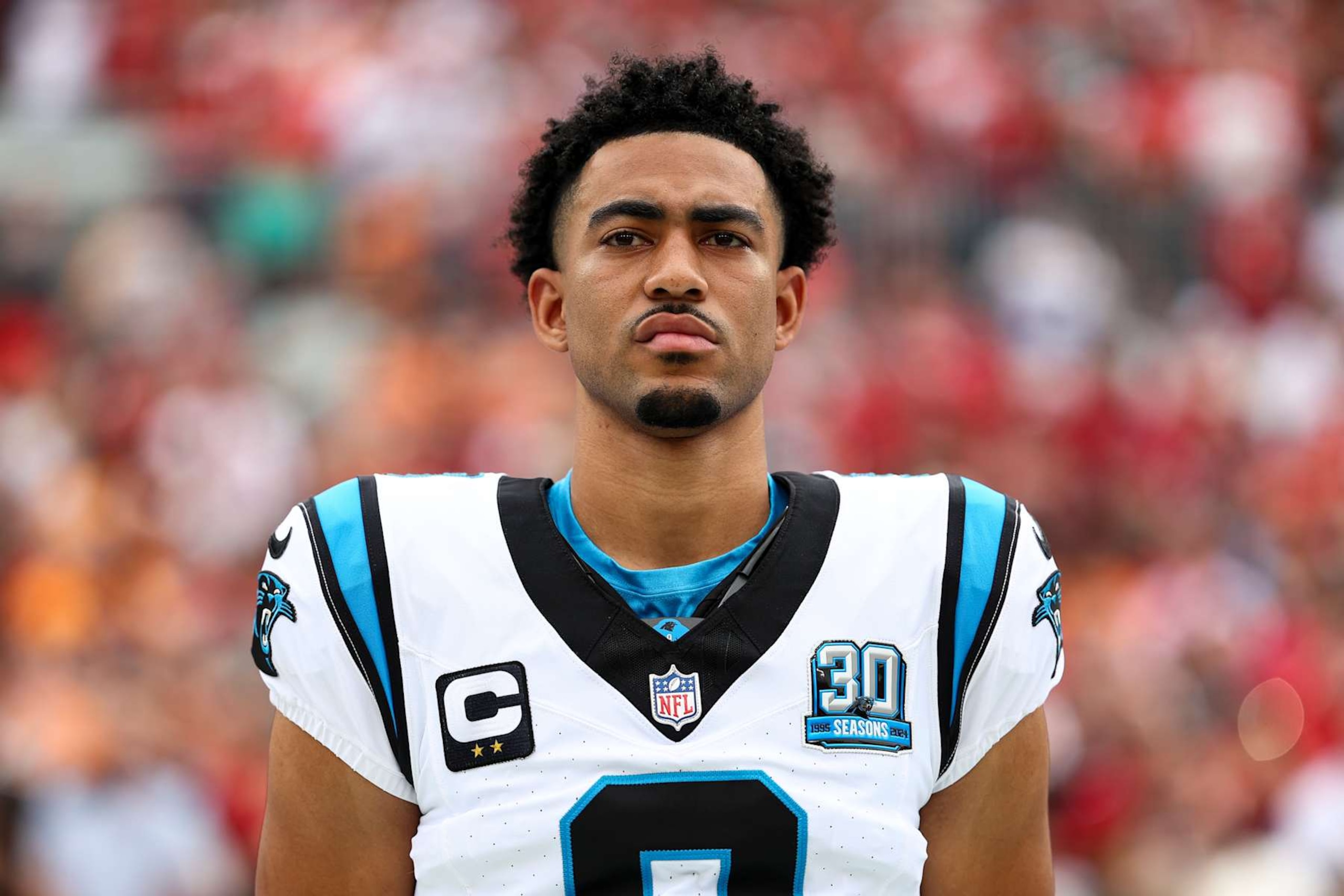 TAMPA, FLORIDA - DECEMBER 29: Bryce Young #9 of the Carolina Panthers stands on the sidelines during the national anthem prior to of an NFL football game against the Tampa Bay Buccaneers at Raymond James Stadium on December 29, 2024 in Tampa, Florida. (Photo by Kevin Sabitus/Getty Images) TAMPA, FLORIDA - DECEMBER 29: Bryce Young #9 of the Carolina Panthers stands on the sidelines during the national anthem prior to of an NFL football game against the Tampa Bay Buccaneers at Raymond James Stadium on December 29, 2024 in Tampa, Florida. (Photo by Kevin Sabitus/Getty Images)