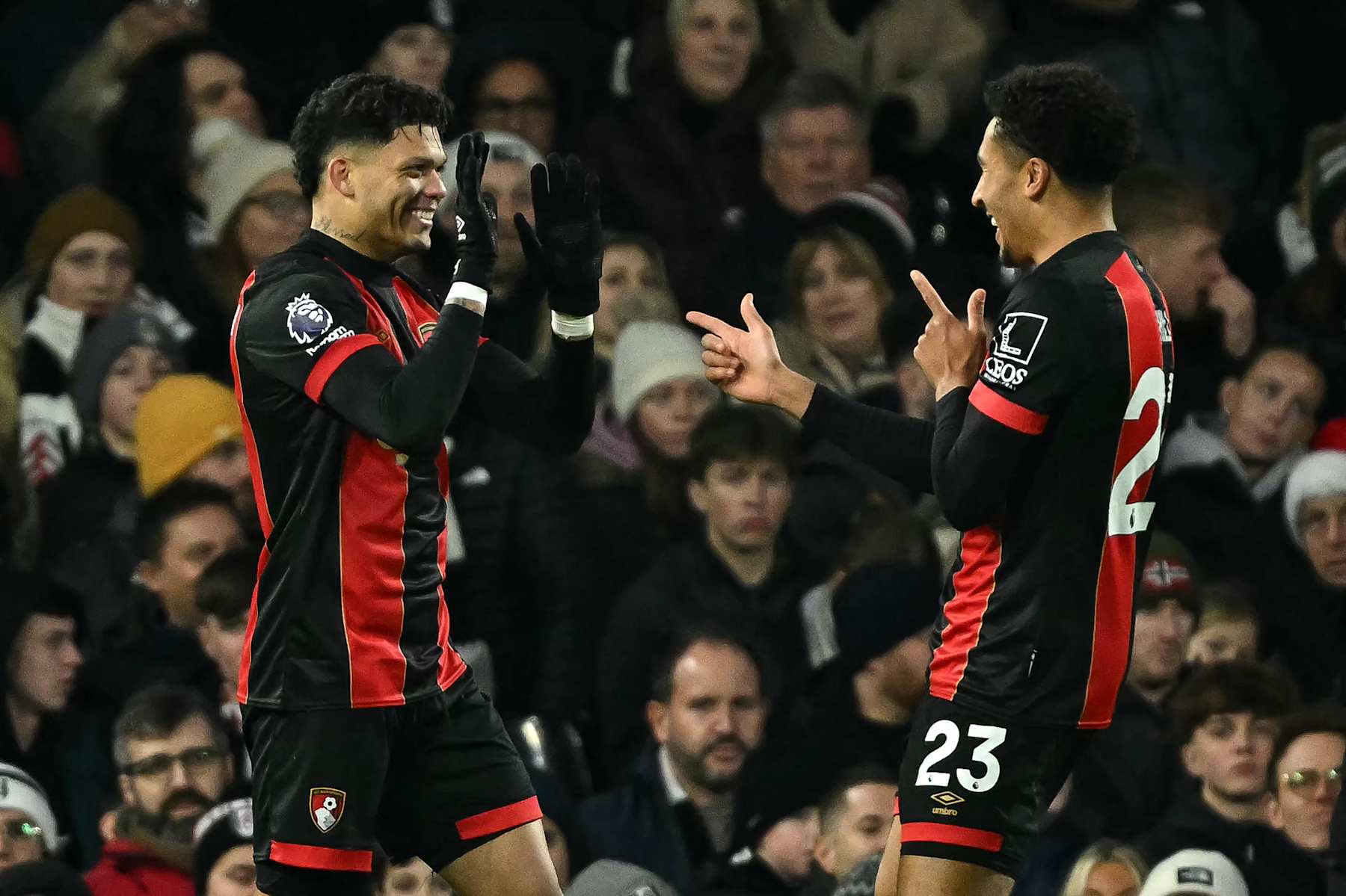 Bournemouth's Brazilian striker #09 Evanilson celebrates after scoring the equalising goal with Bournemouth's English defender #23 James Hill (R) during the English Premier League football match between Fulham and Bournemouth at Craven Cottage in London on December 29, 2024. (Photo by JUSTIN TALLIS / AFP) / RESTRICTED TO EDITORIAL USE. No use with unauthorized audio, video, data, fixture lists, club/league logos or 'live' services. Online in-match use limited to 120 images. An additional 40 images may be used in extra time. No video emulation. Social media in-match use limited to 120 images. An additional 40 images may be used in extra time. No use in betting publications, games or single club/league/player publications. /  (Photo by JUSTIN TALLIS/AFP via Getty Images)