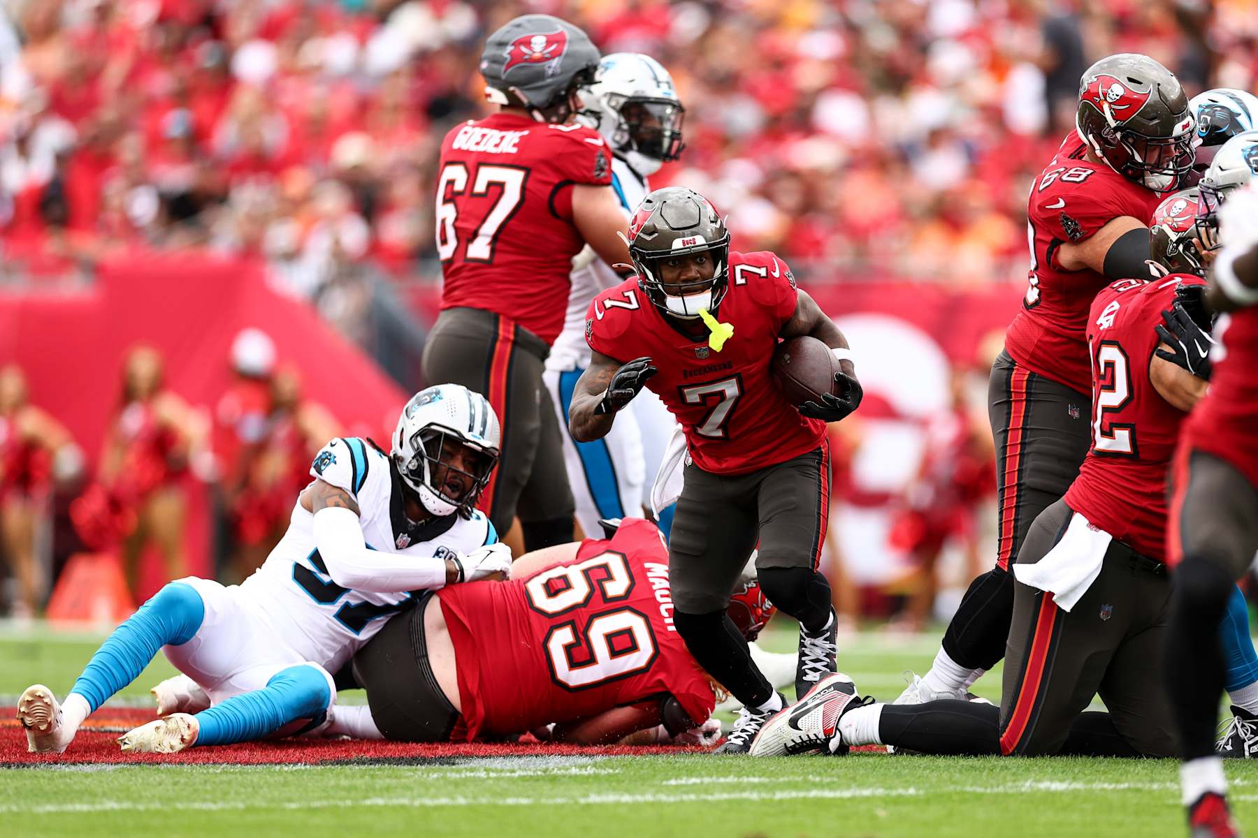 TAMPA, FLORIDA - DECEMBER 29: Bucky Irving #7 of the Tampa Bay Buccaneers carries the ball during the first half of an NFL football game against the Carolina Panthers at Raymond James Stadium on December 29, 2024 in Tampa, Florida. (Photo by Kevin Sabitus/Getty Images)