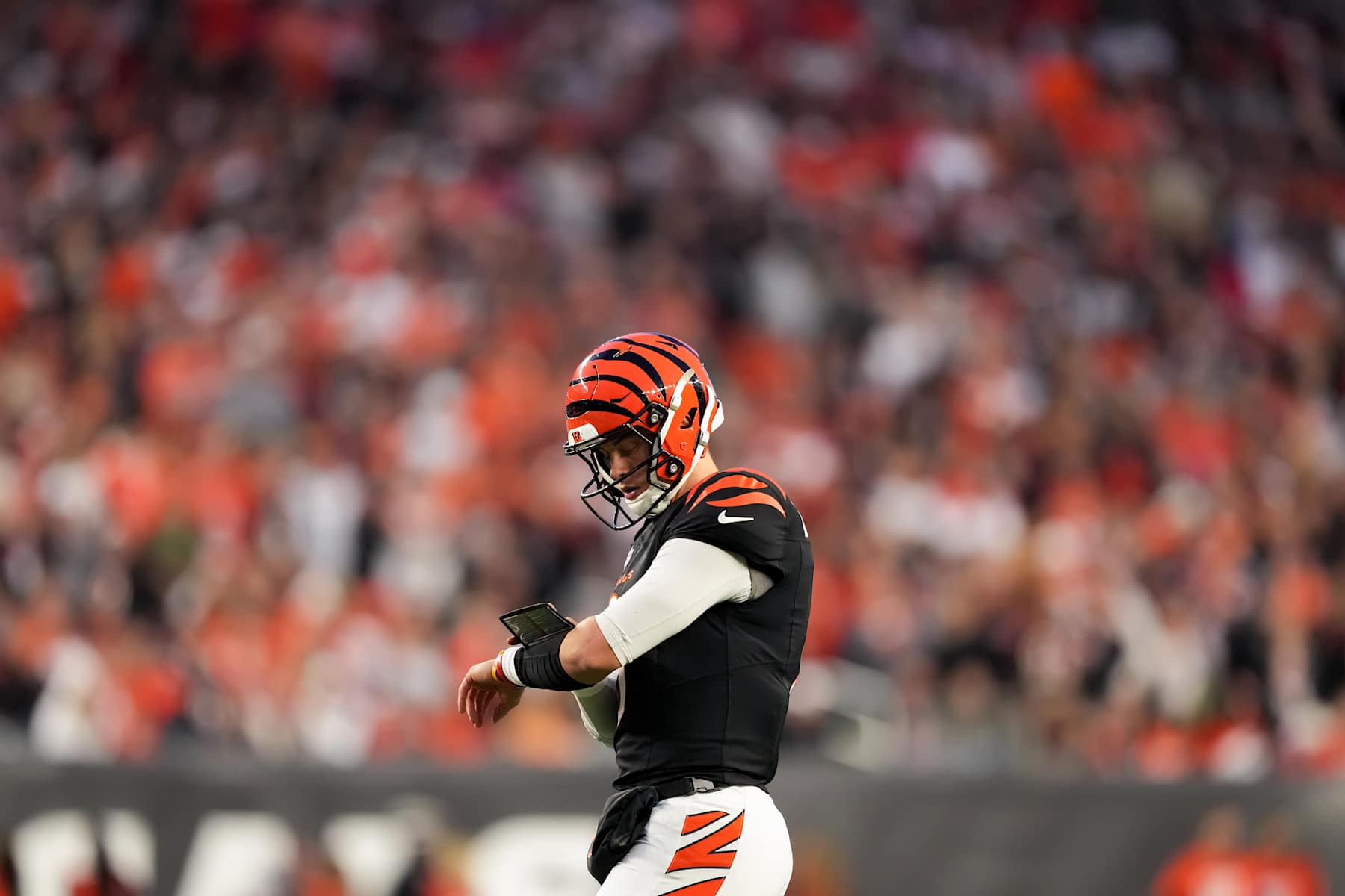 CINCINNATI, OHIO - DECEMBER 28: Joe Burrow #9 of the Cincinnati Bengals checks his wristband in the second quarter against the Denver Broncos at Paycor Stadium on December 28, 2024 in Cincinnati, Ohio. (Photo by Dylan Buell/Getty Images)