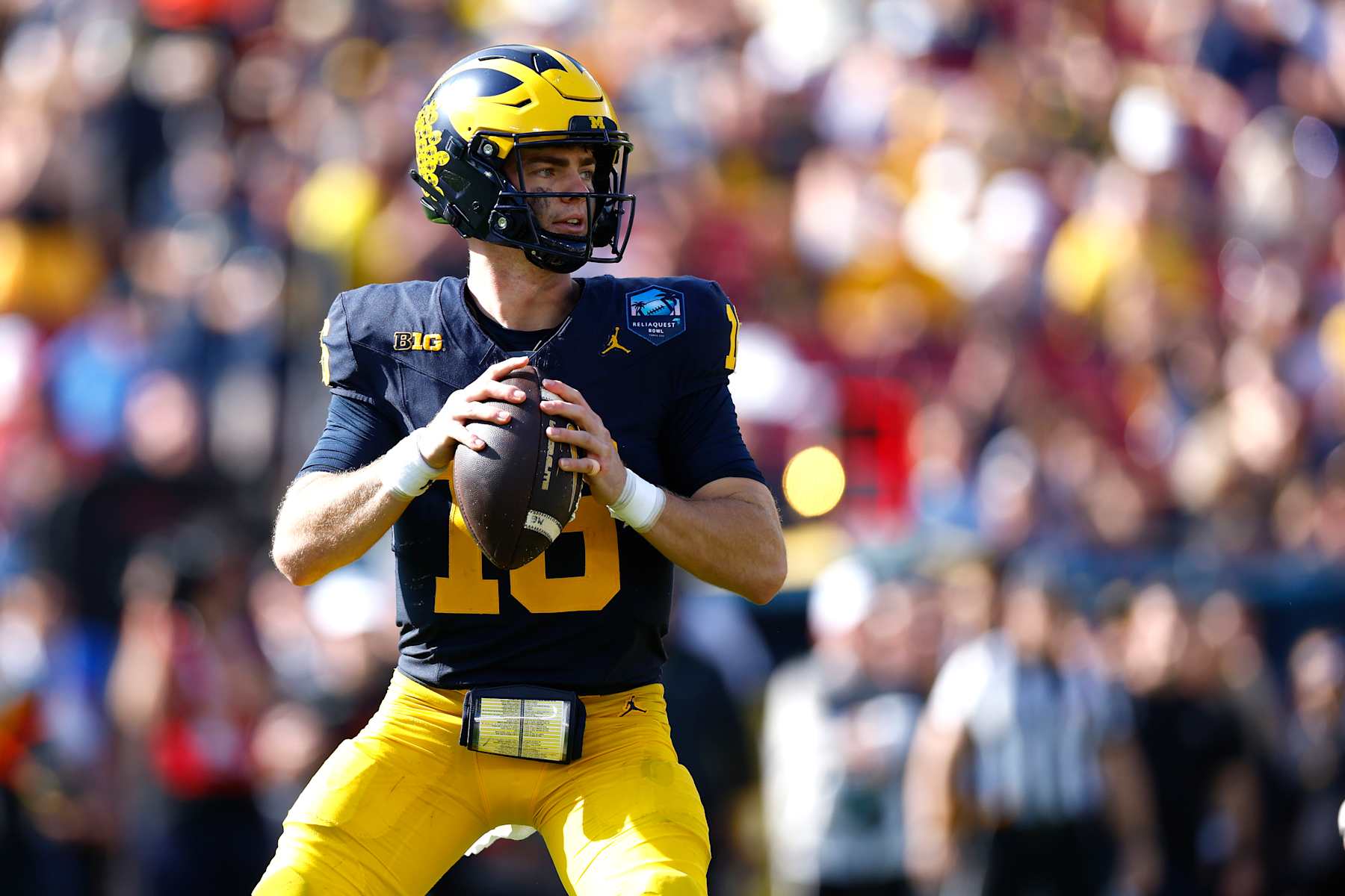 TAMPA, FLORIDA - DECEMBER 31: Davis Warren #16 of the Michigan Wolverines looks to pass against the Alabama Crimson Tide during the third quarter in the 2024 ReliaQuest Bowl at Raymond James Stadium on December 31, 2024 in Tampa, Florida.  (Photo by Douglas P. DeFelice/Getty Images)