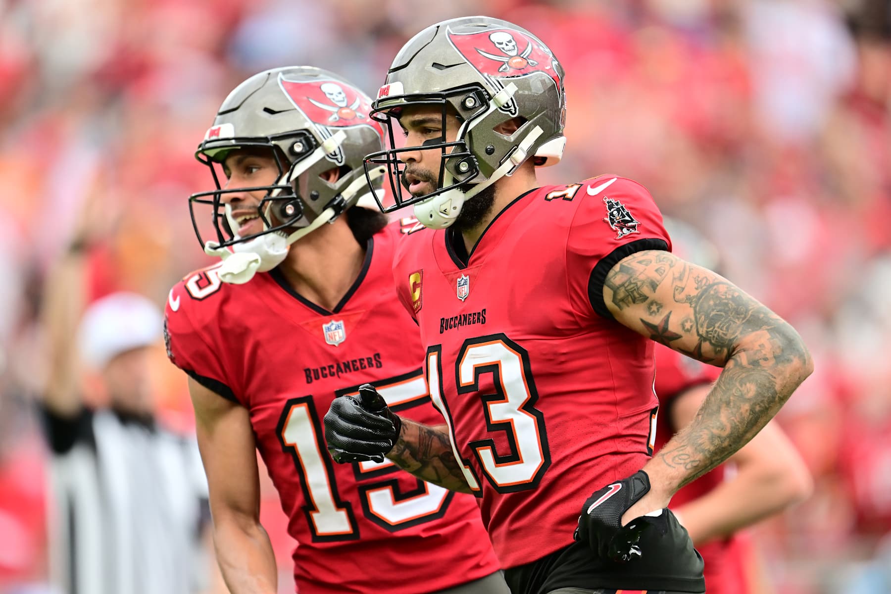 TAMPA, FLORIDA - DECEMBER 29: Jalen McMillan #15 and Mike Evans #13 of the Tampa Bay Buccaneers celebrate a touchdown  in the second quarter against the Carolina Panthers  at Raymond James Stadium on December 29, 2024 in Tampa, Florida. (Photo by Julio Aguilar/Getty Images)