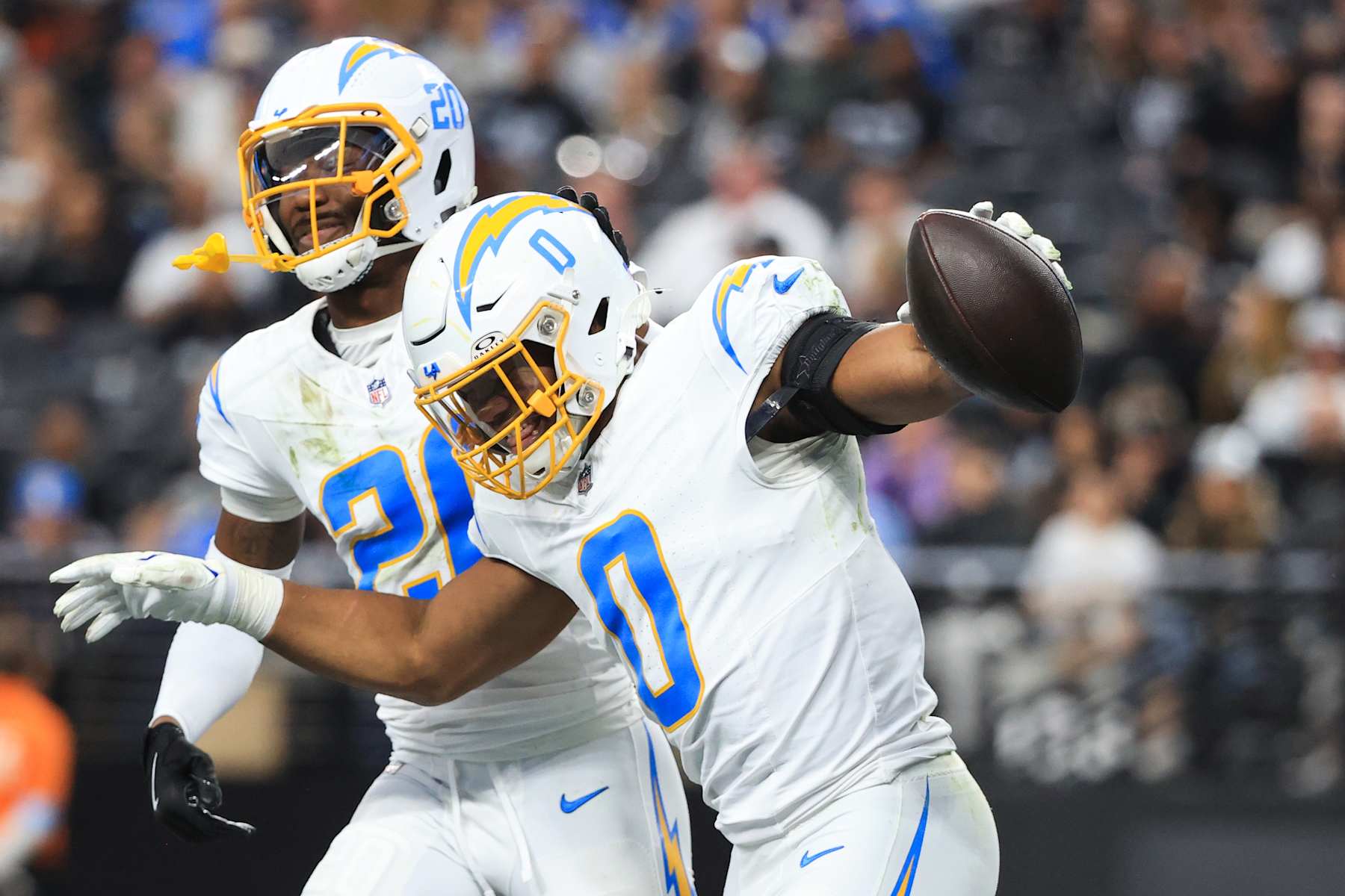 LAS VEGAS, NEVADA - JANUARY 05: Daiyan Henley #0 of the Los Angeles Chargers celebrates with teammate Cam Hart #20 after an interception against the Las Vegas Raiders during the second quarter at Allegiant Stadium on January 05, 2025 in Las Vegas, Nevada. (Photo by Ian Maule/Getty Images)