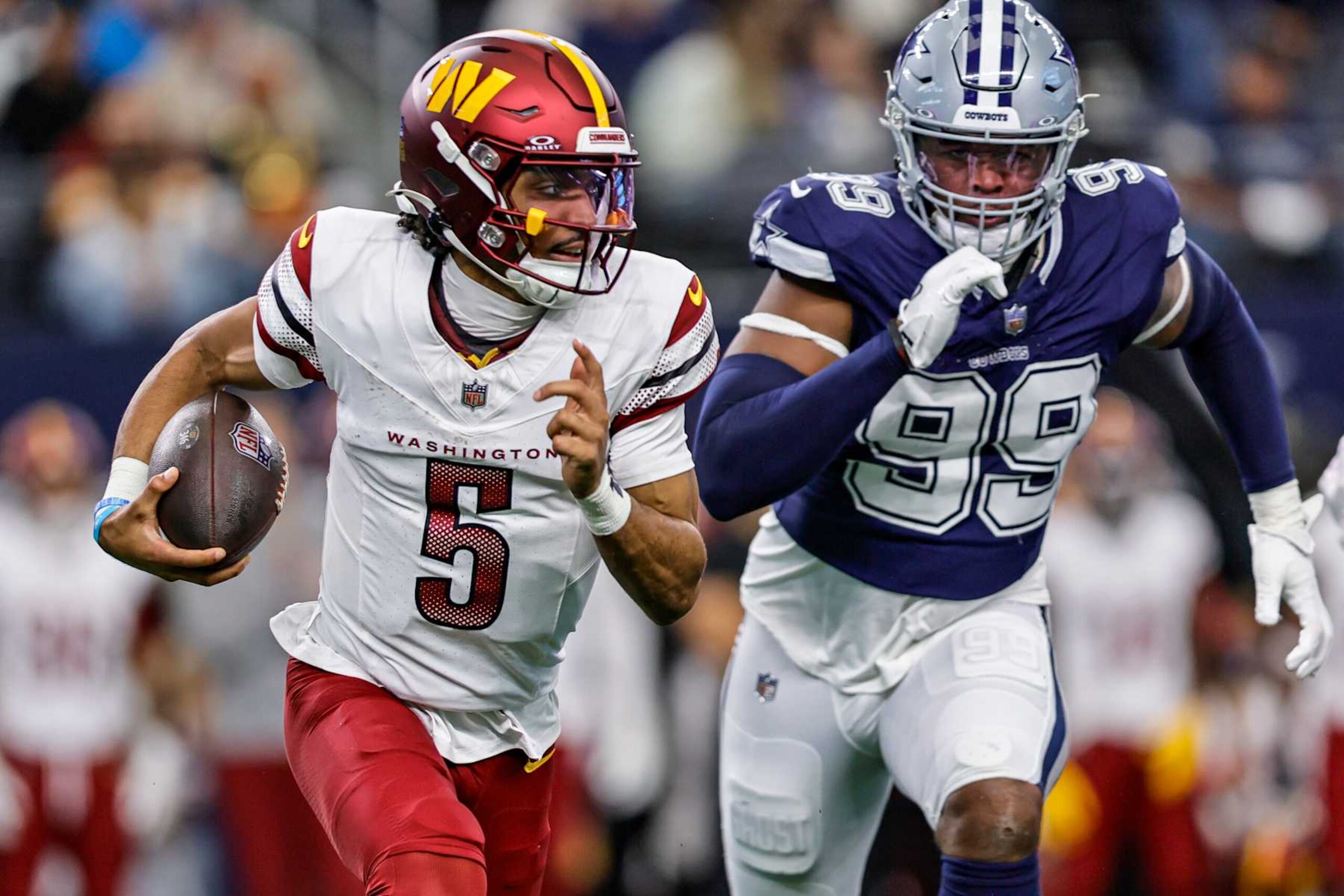 ARLINGTON, TX - JANUARY 05: Washington Commanders quarterback Jayden Daniels (5) runs a quarterback keeper chase by Dallas Cowboys defensive end Chauncey Golston (99) during the game between the Dallas Cowboys and the Washington Commanders on January 5, 2025 at AT&T Stadium in Arlington, Texas. (Photo by Matthew Pearce/Icon Sportswire via Getty Images) ARLINGTON, TX - JANUARY 05: Washington Commanders quarterback Jayden Daniels (5) runs a quarterback keeper chase by Dallas Cowboys defensive end Chauncey Golston (99) during the game between the Dallas Cowboys and the Washington Commanders on January 5, 2025 at AT&T Stadium in Arlington, Texas. (Photo by Matthew Pearce/Icon Sportswire via Getty Images)