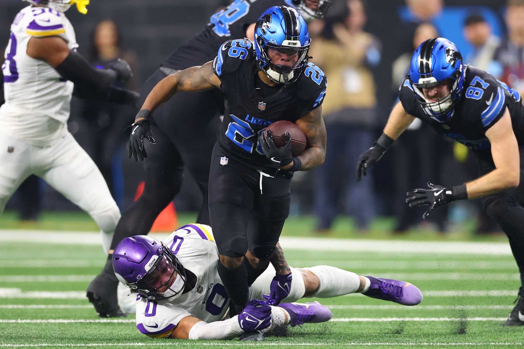 DETROIT, MICHIGAN - JANUARY 05: Jahmyr Gibbs #26 of the Detroit Lions is tackled by Ivan Pace Jr. #0 of the Minnesota Vikings during the second quarter at Ford Field on January 05, 2025 in Detroit, Michigan. (Photo by Gregory Shamus/Getty Images)
