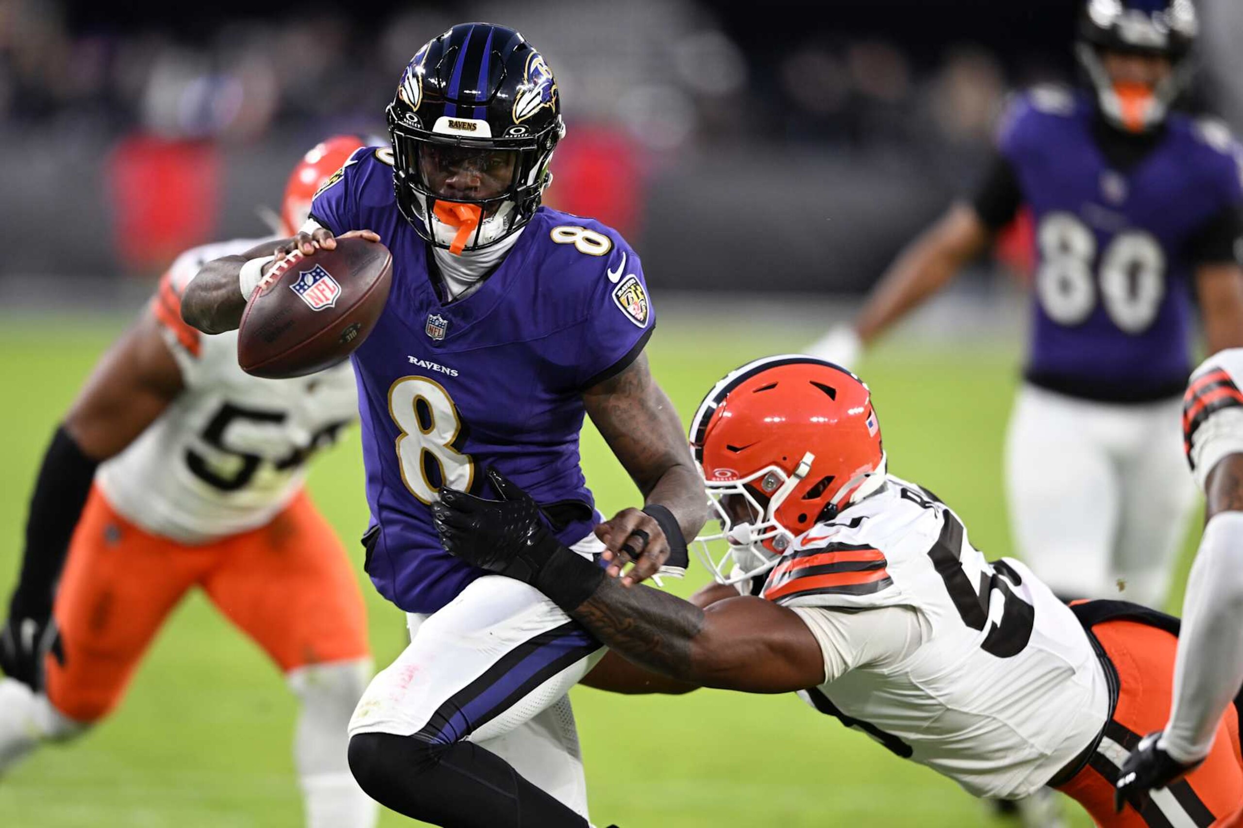 BALTIMORE, MARYLAND - JANUARY 04: Lamar Jackson #8 of the Baltimore Ravens runs with the ball while defended by Winston Reid #59 of the Cleveland Browns during the first quarter at M&T Bank Stadium on January 04, 2025 in Baltimore, Maryland. (Photo by Greg Fiume/Getty Images) BALTIMORE, MARYLAND - JANUARY 04: Lamar Jackson #8 of the Baltimore Ravens runs with the ball while defended by Winston Reid #59 of the Cleveland Browns during the first quarter at M&T Bank Stadium on January 04, 2025 in Baltimore, Maryland. (Photo by Greg Fiume/Getty Images)