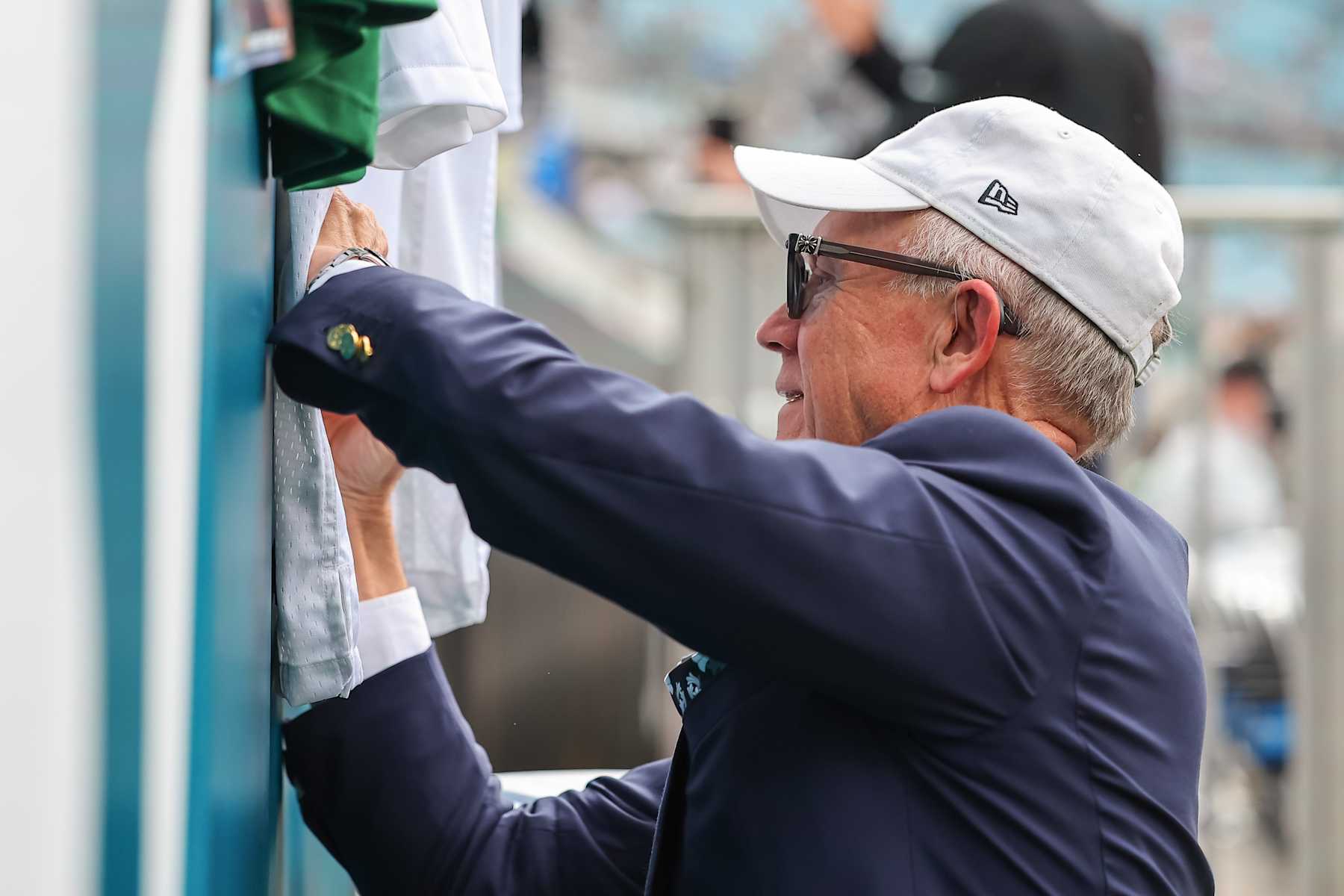 JACKSONVILLE, FLORIDA - DECEMBER 15: Owner Woody Johnson of the New York Jets signs for fans prior to the game against the Jacksonville Jaguars at EverBank Field on December 15, 2024 in Jacksonville, Florida. (Photo by Mike Carlson/Getty Images)