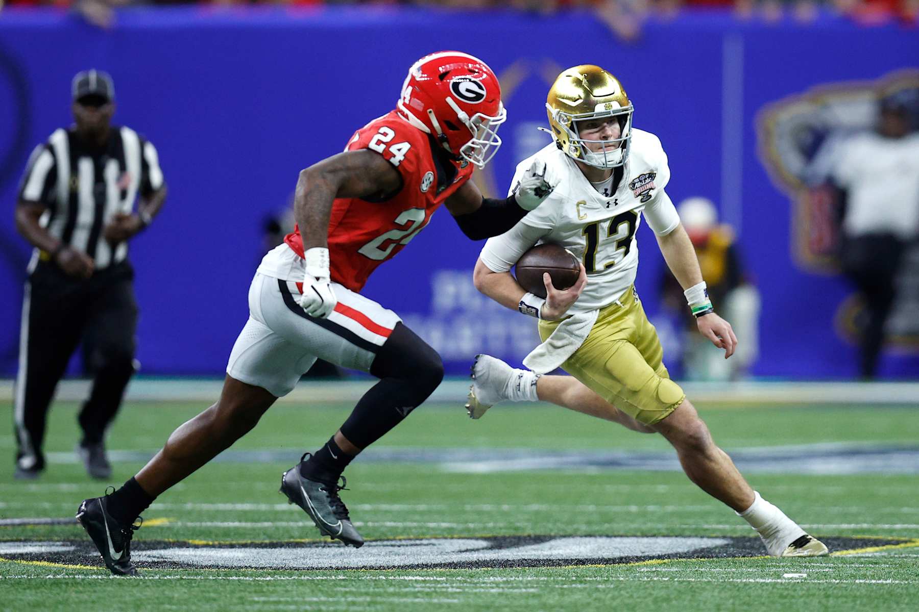 NEW ORLEANS, LOUISIANA - JANUARY 02: Riley Leonard #13 of the Notre Dame Fighting Irish carries the ball against Malaki Starks #24 of the Georgia Bulldogs during the third quarter during the 91st Allstate Sugar Bowl at Caesars Superdome on January 02, 2025 in New Orleans, Louisiana. (Photo by Sean Gardner/Getty Images) NEW ORLEANS, LOUISIANA - JANUARY 02: Riley Leonard #13 of the Notre Dame Fighting Irish carries the ball against Malaki Starks #24 of the Georgia Bulldogs during the third quarter during the 91st Allstate Sugar Bowl at Caesars Superdome on January 02, 2025 in New Orleans, Louisiana. (Photo by Sean Gardner/Getty Images)