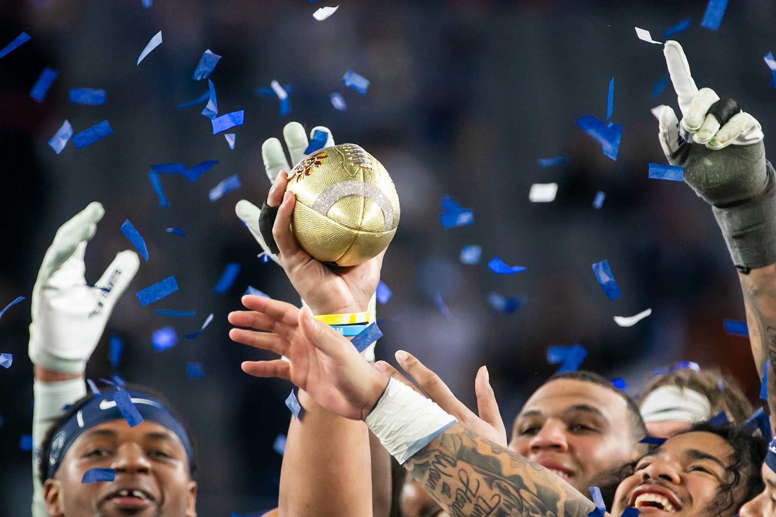 GLENDALE, AZ - DECEMBER 31: Members of the Penn State Football hold up the championship trophy after their victory over the Boise State Broncos during the College Football Playoff Quarterfinal at the Vrbo Fiesta Bowl on December 31, 2024, at State Farm Stadium in Glendale, AZ.  (Photo by Nick Tre. Smith/Icon Sportswire via Getty Images)