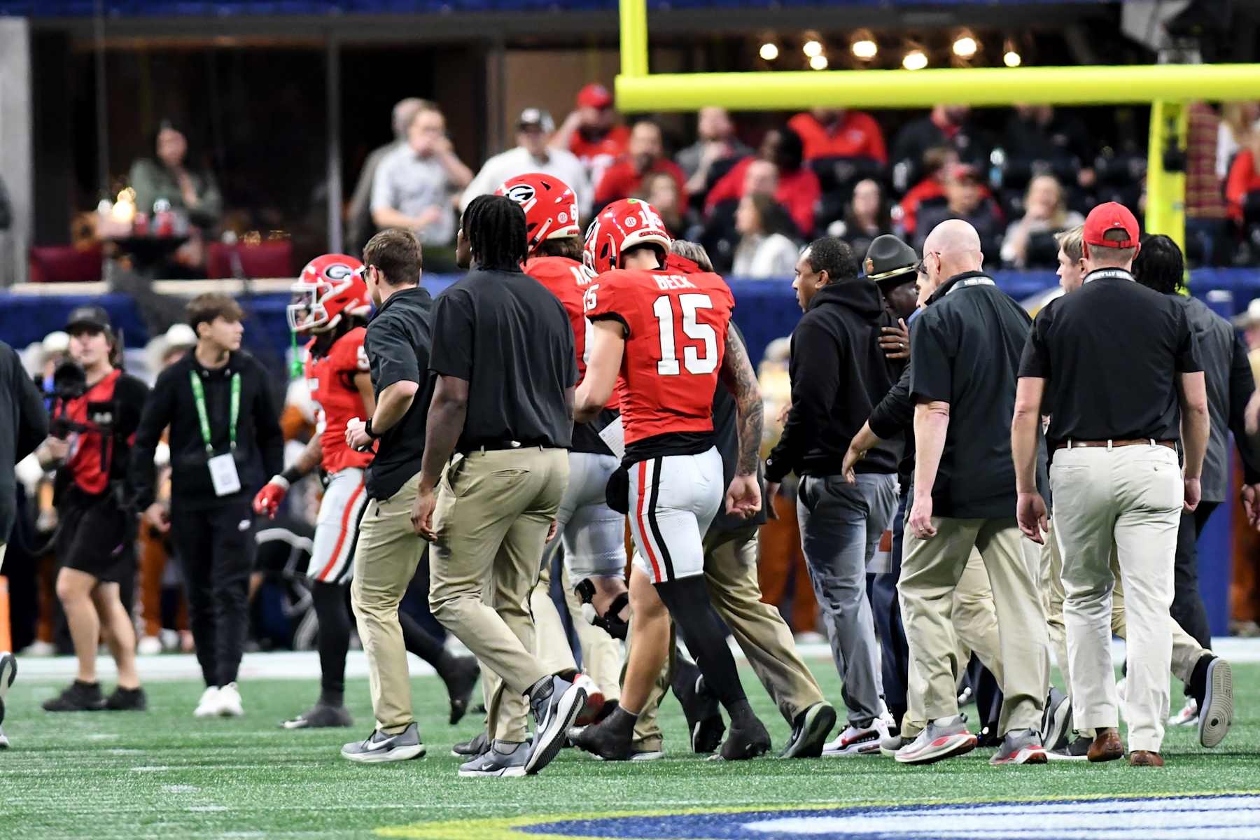 ATLANTA, GA - DECEMBER 7: Carson Beck #15 of the Georgia Bulldogs leaves the field injured on the final play of the first half during a game between University of Texas and University of Georgia at Mercedes-Benz Stadium on December 7, 2024 in Atlanta, Georgia. (Photo by Perry McIntyre/ISI Photos/Getty Images)