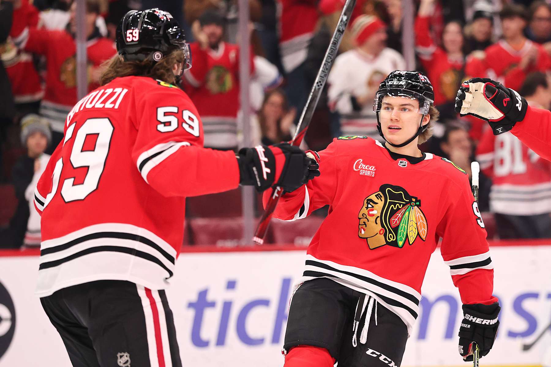 CHICAGO, ILLINOIS - JANUARY 05: Connor Bedard #98 of the Chicago Blackhawks celebrates after assisting a goal by Tyler Bertuzzi #59 against the New York Rangers during the first period at the United Center on January 05, 2025 in Chicago, Illinois. (Photo by Michael Reaves/Getty Images)