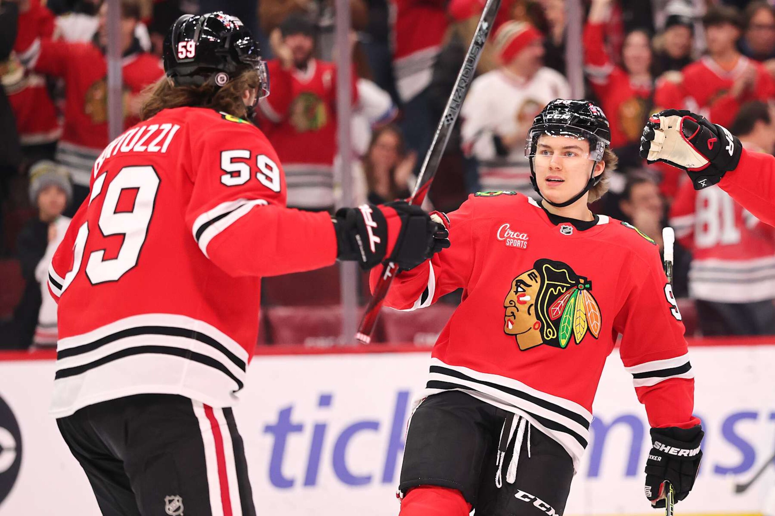 CHICAGO, ILLINOIS - JANUARY 05: Connor Bedard #98 of the Chicago Blackhawks celebrates after assisting a goal by Tyler Bertuzzi #59 against the New York Rangers during the first period at the United Center on January 05, 2025 in Chicago, Illinois. (Photo by Michael Reaves/Getty Images) CHICAGO, ILLINOIS - JANUARY 05: Connor Bedard #98 of the Chicago Blackhawks celebrates after assisting a goal by Tyler Bertuzzi #59 against the New York Rangers during the first period at the United Center on January 05, 2025 in Chicago, Illinois. (Photo by Michael Reaves/Getty Images)