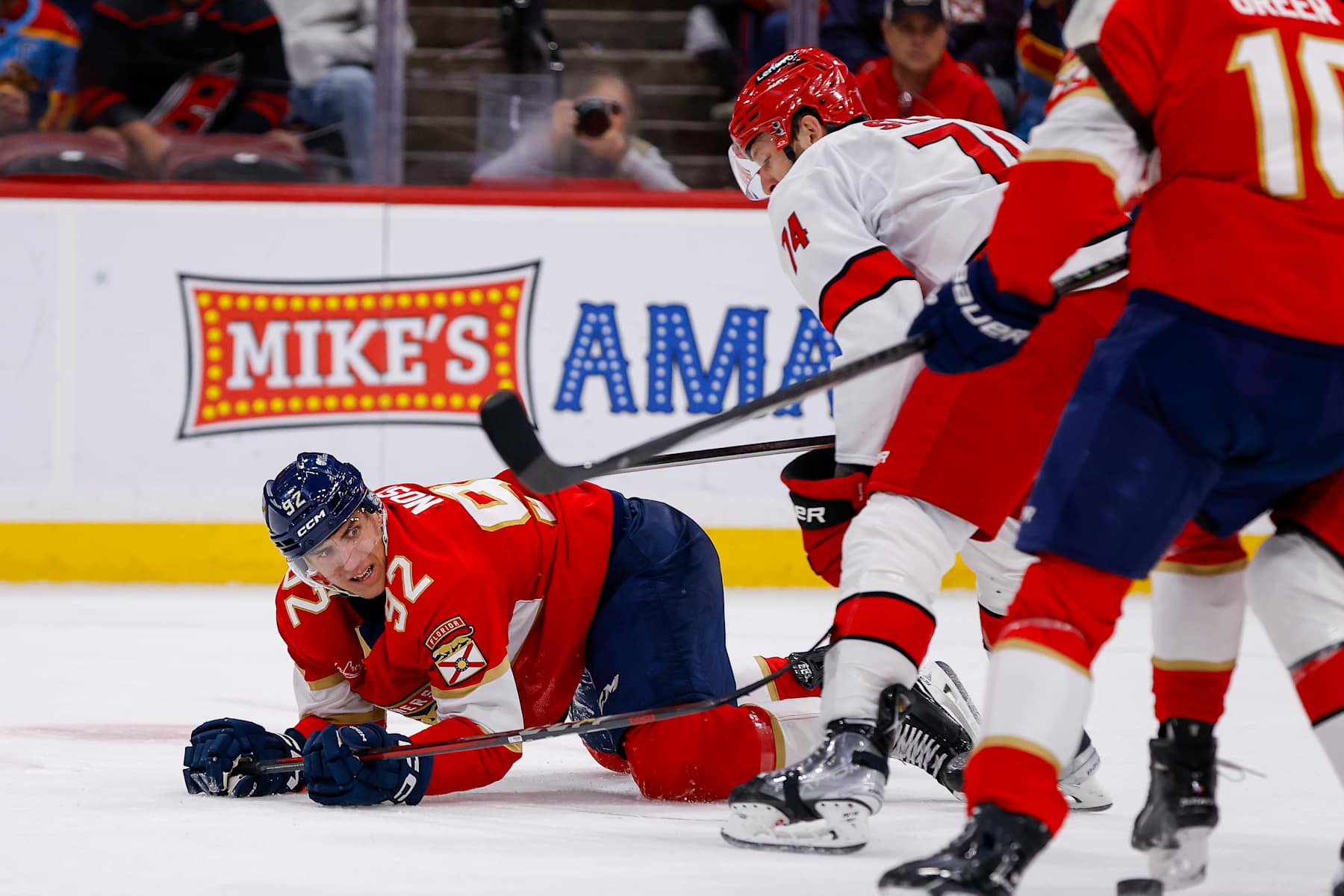 SUNRISE, FL - JANUARY 02: Florida Panther Tomas Nosek (92) (L) falls to the ice as Carolina Hurricane Jaccob Slavin (74) (R) looks on during the game between the Carolina Hurricanes and the Florida Panthers on Thursday January 2, 2025 at Amerant Bank Arena in Sunrise, Fla. (Photo by Chris Arjoon/Icon Sportswire via Getty Images)