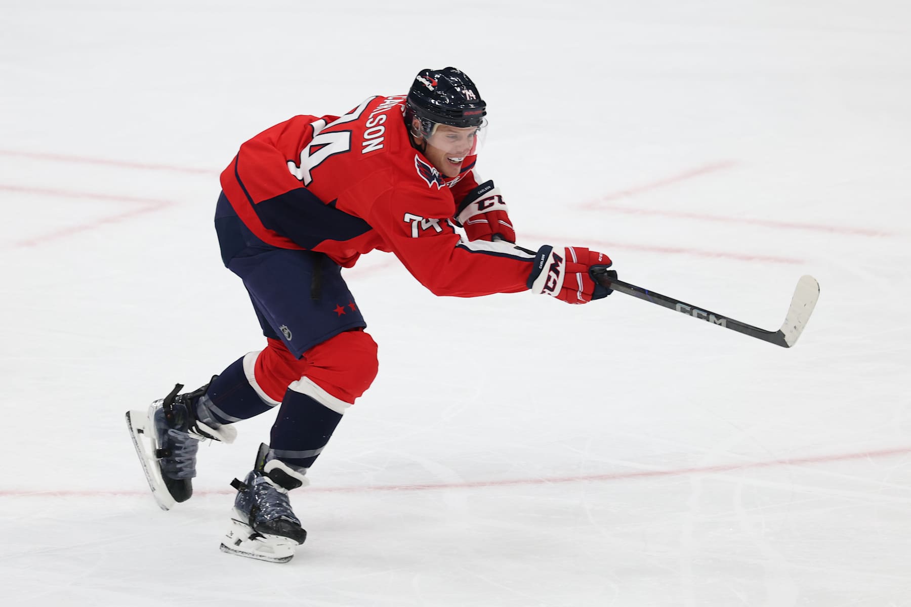 WASHINGTON, DC - JANUARY 04: John Carlson #74 of the Washington Capitals clears the puck against the New York Rangers during the first period at Capital One Arena on January 04, 2025 in Washington, DC. (Photo by Patrick Smith/Getty Images)