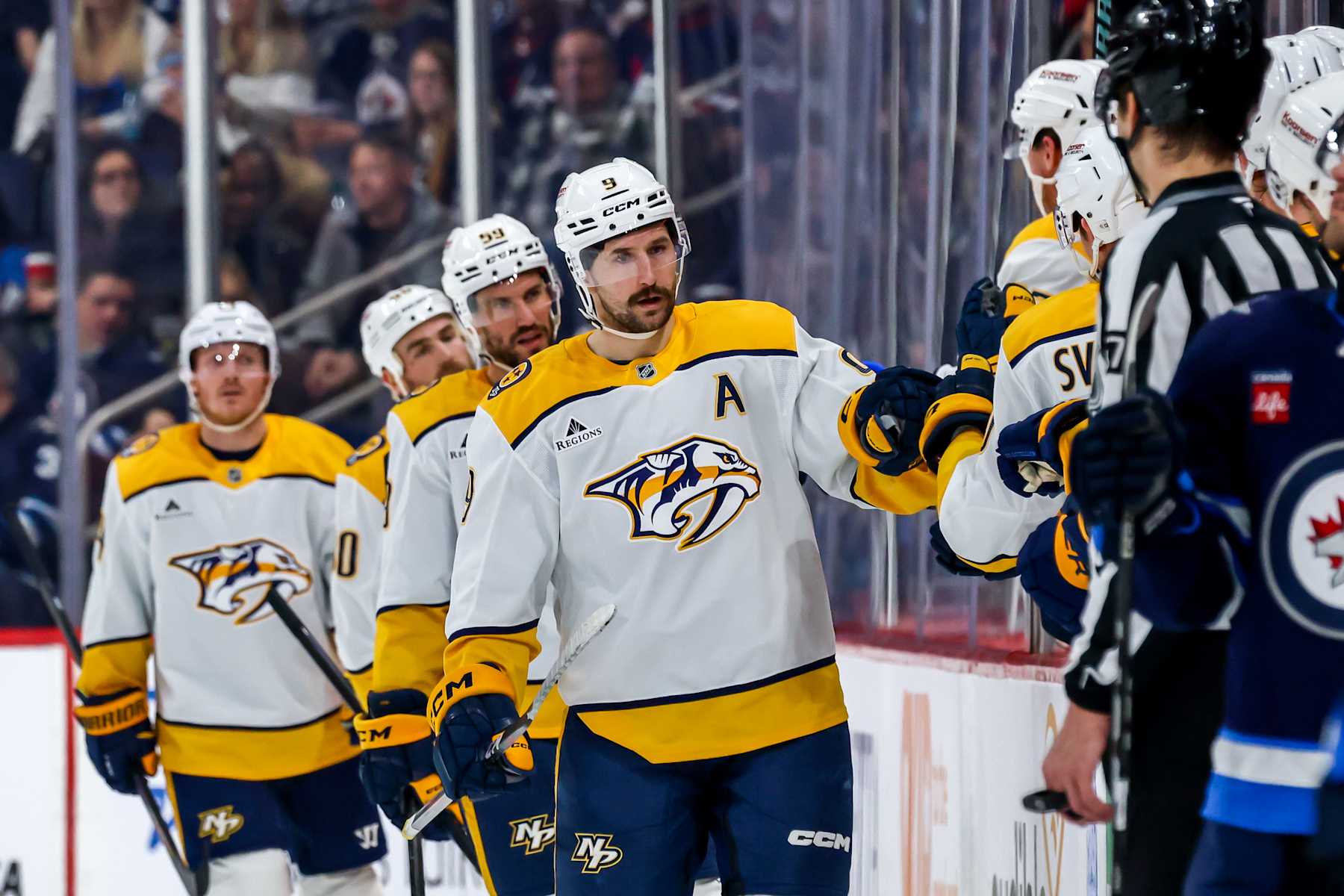 WINNIPEG, CANADA - JANUARY 7: Filip Forsberg #9 of the Nashville Predators celebrates his second period goal against the Winnipeg Jets with teammates at the bench at the Canada Life Centre on January 7, 2025 in Winnipeg, Manitoba, Canada. (Photo by Jonathan Kozub/NHLI via Getty Images)